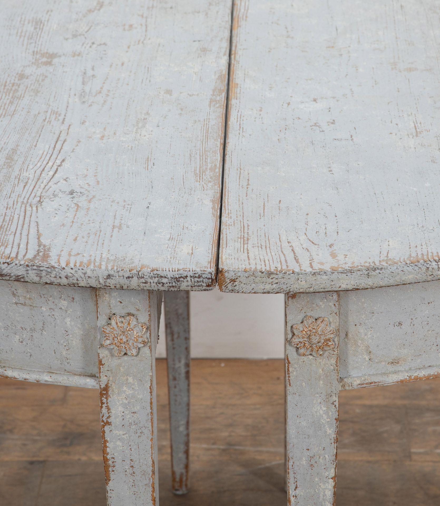 Pair of Swedish 18th century demi-lunes.
In original blue-grey hue of light paint which has been scraped back.
With a simple classic Swedish motif image on the apron.
Circa 1790.