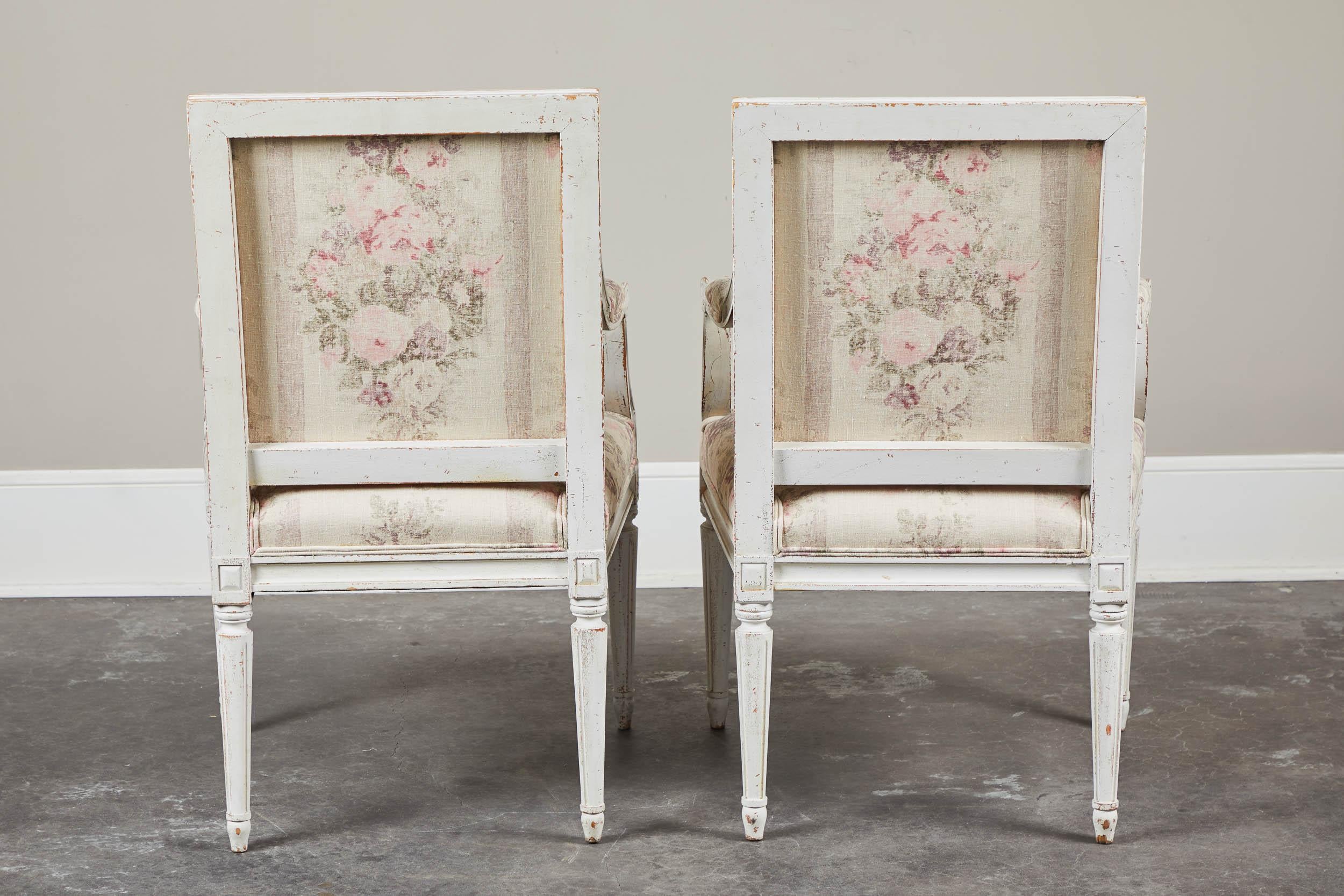 Pair of 18th century white painted Gustavian armchairs with new upholstery. Great antique condition. Versatile uses; as a desk chair, reading chair in bedroom, vanity seating or simply a place to put your purse down in an entryway.