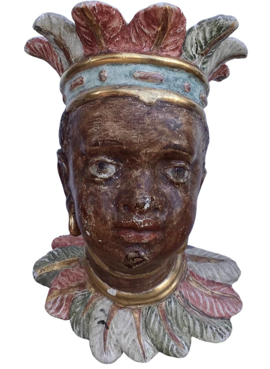 Rare pair Of 18th century Venetian Rococo period polychromed antique carved wood sculptures in the form of nubian heads. 
Each with substantial traces of original polychrome, portrayed wearing feathered headdresses and collars, their ears pierced