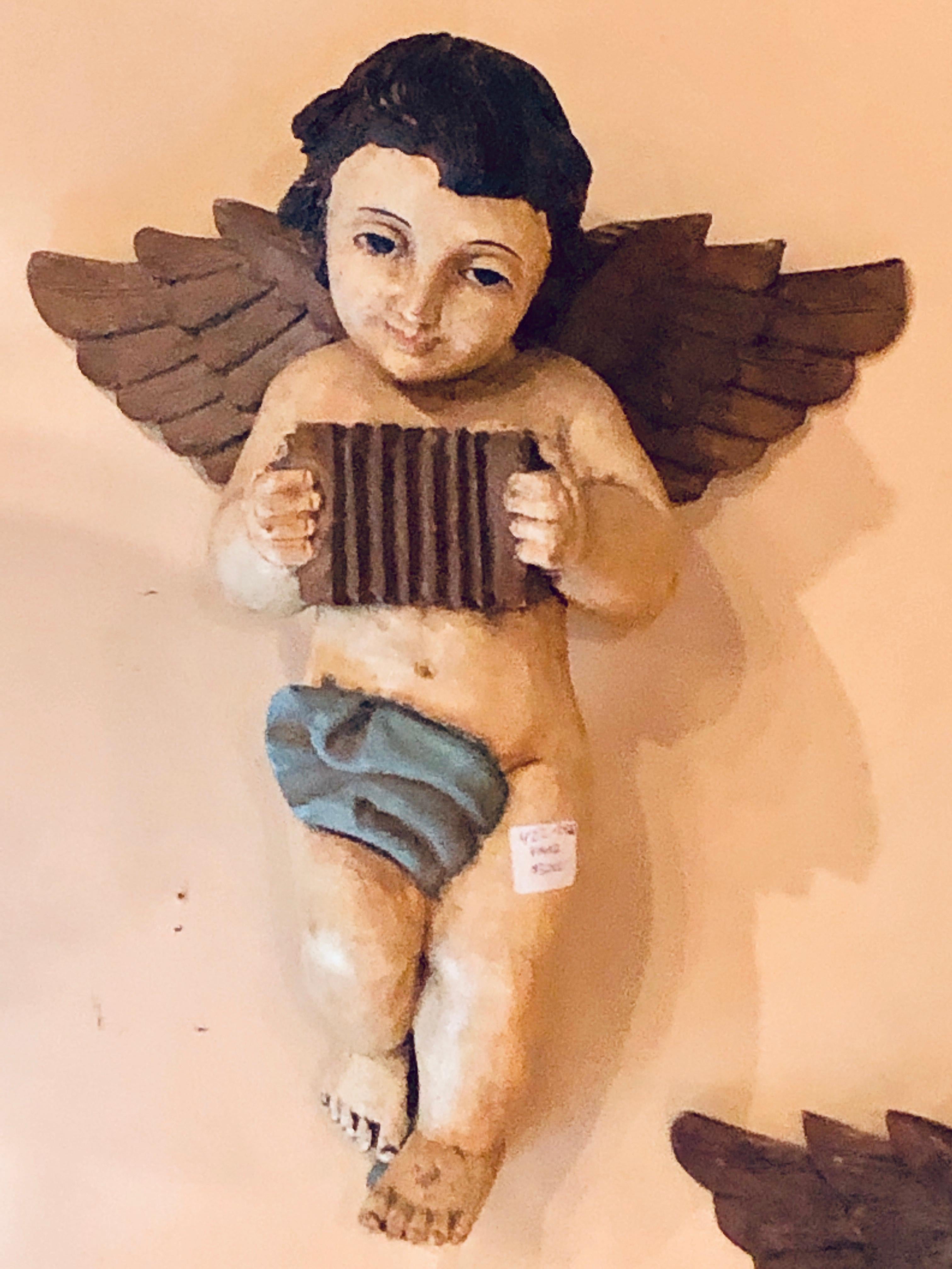 Pair of 19th-20th century continental painted antique winged babies or cherubs. Sweet as can be as these finely painted winged babies in their original finish. Most likely Italian.
