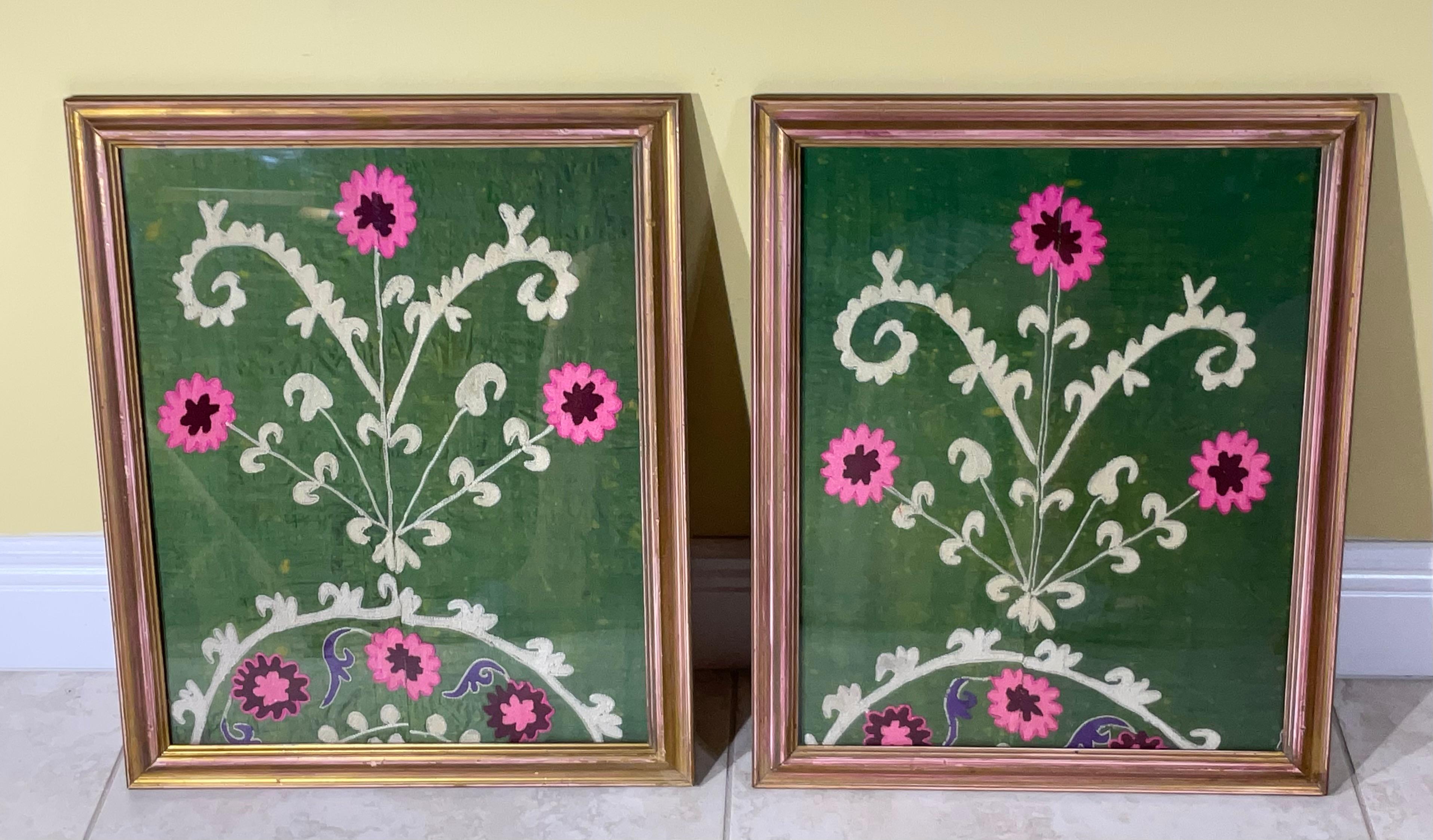 Beautiful pair of wall handing made of silk hand embroidery on green silk background Suzani textile , floral and vine motif , professionally mounted on cotton backing . 
backing sewn together by hand, framed with front glass, to make ,one of a kind