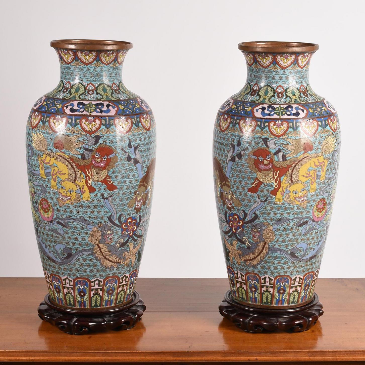 Pair of large and very fine quality unusual Chinese Cloisonne Vases with foo dog motif on rosewood stands. Vases 20 height, 22 inches with stands.