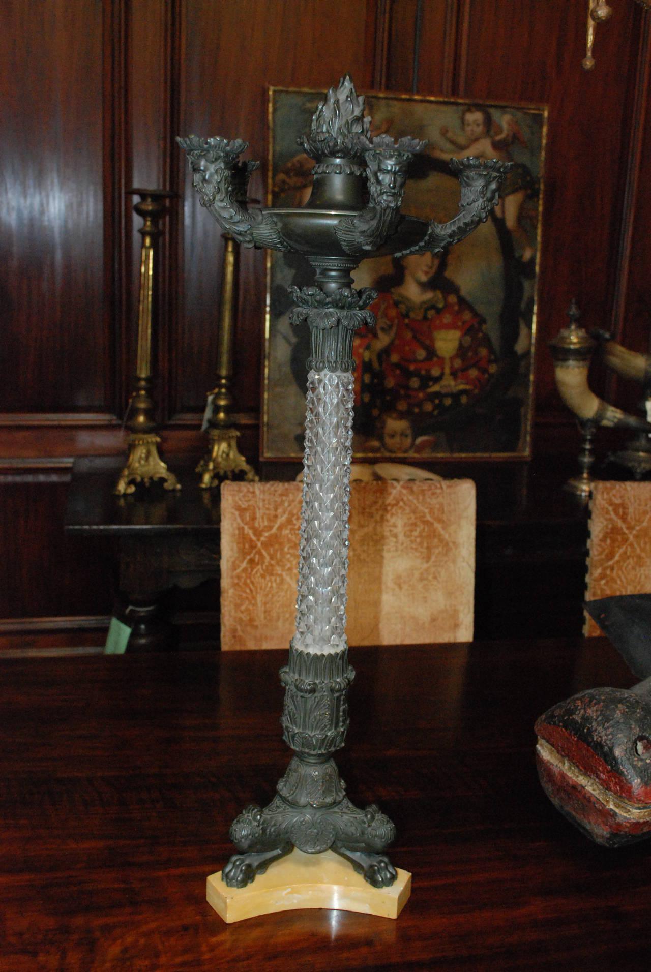 Pair of French candelabrum with crystal stems, sitting on marble. 
  