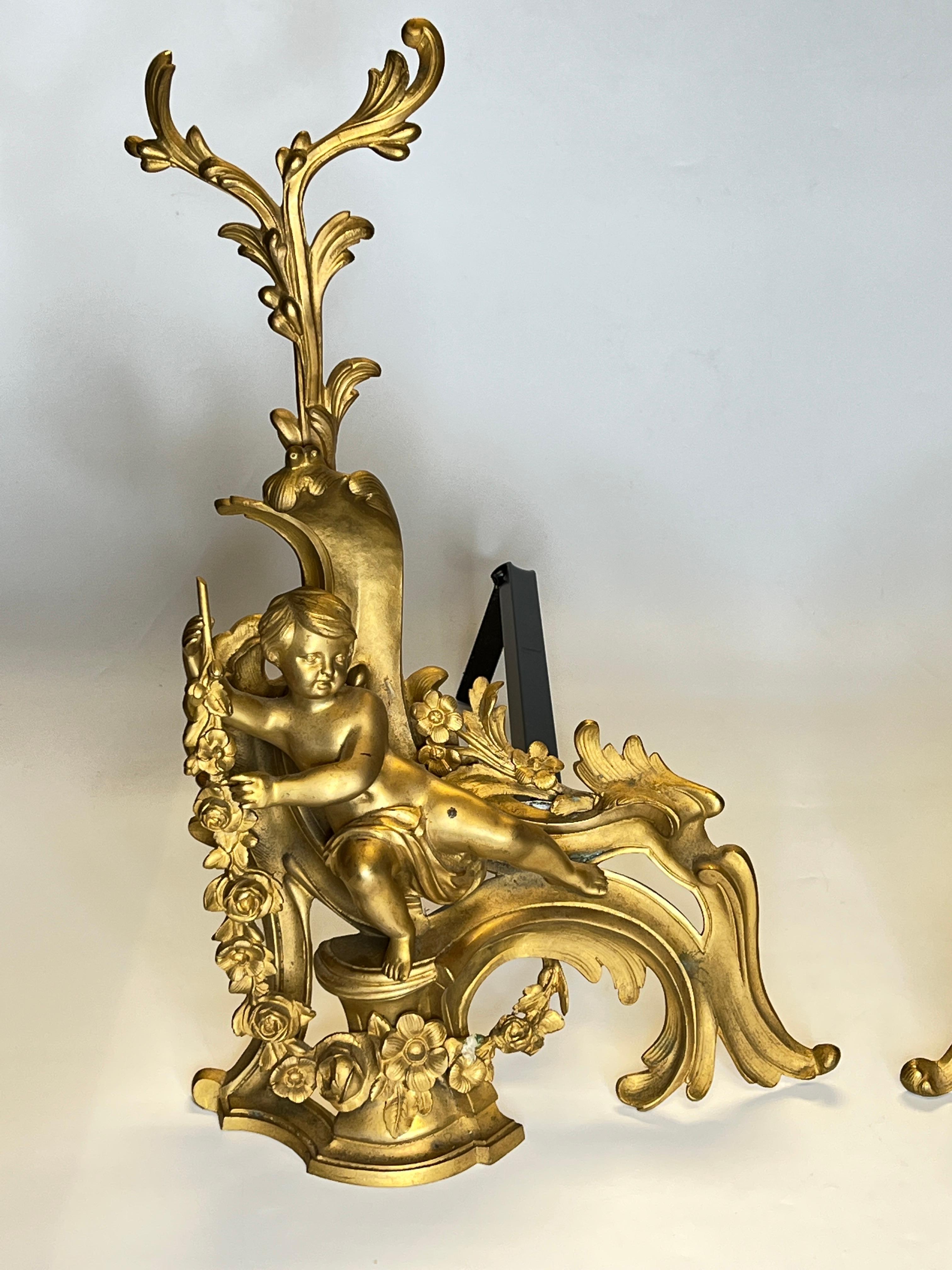 Pair of 19 century French Louis XVI style gilt bronze cherub motif figural andirons / chenets.