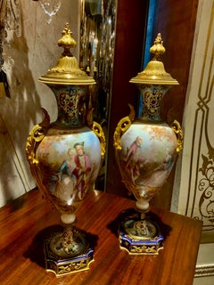 Pair of 19 th c. French urns in the Sevres style with champleve accents