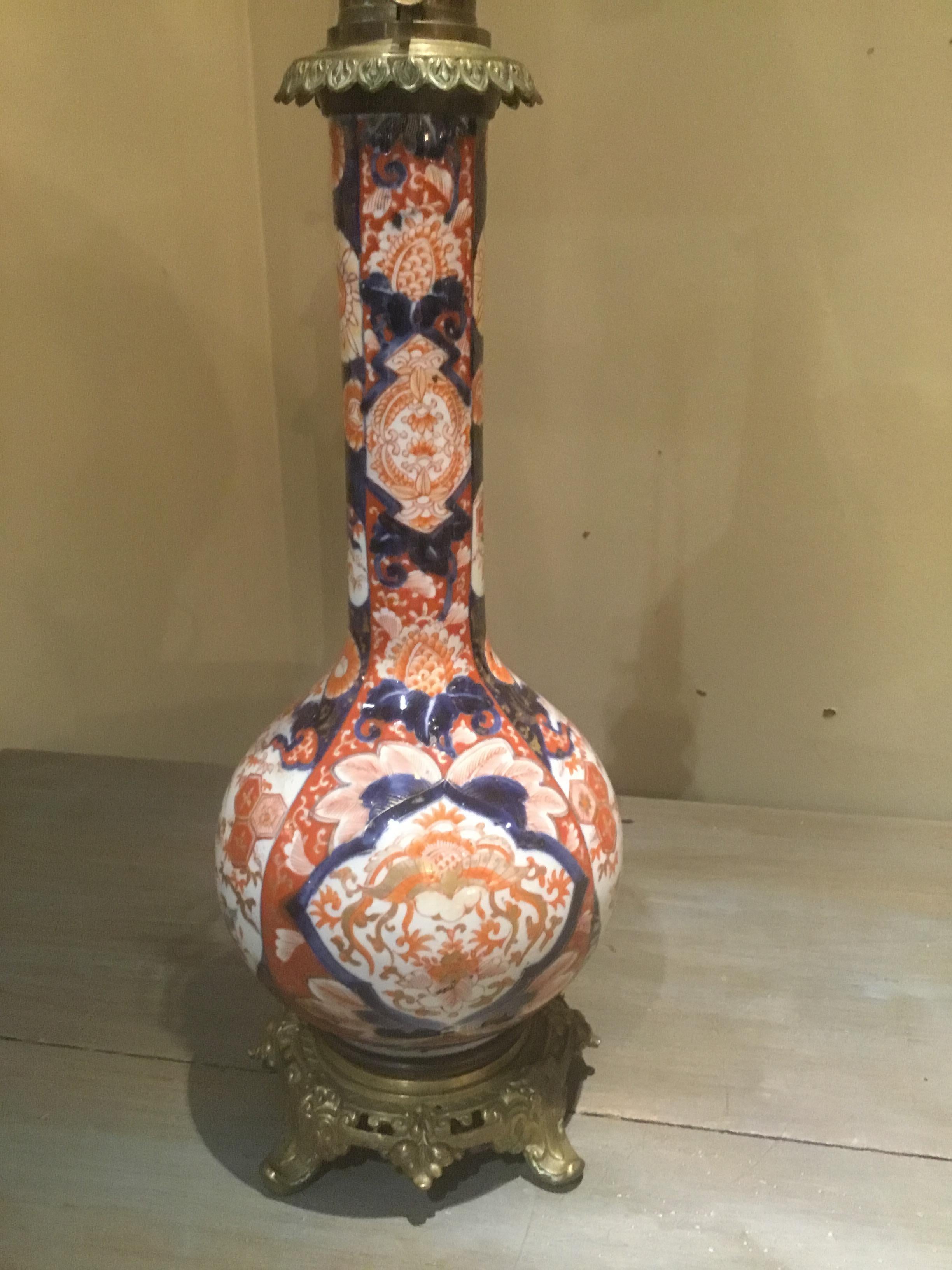 Kerosene lamps that have been converted to electricity. Ovoid shape and painted in the
Traditional Imari hues. Beautiful condition without breaks, cracks or chips. Mounted on
A reticulated bronze base.
