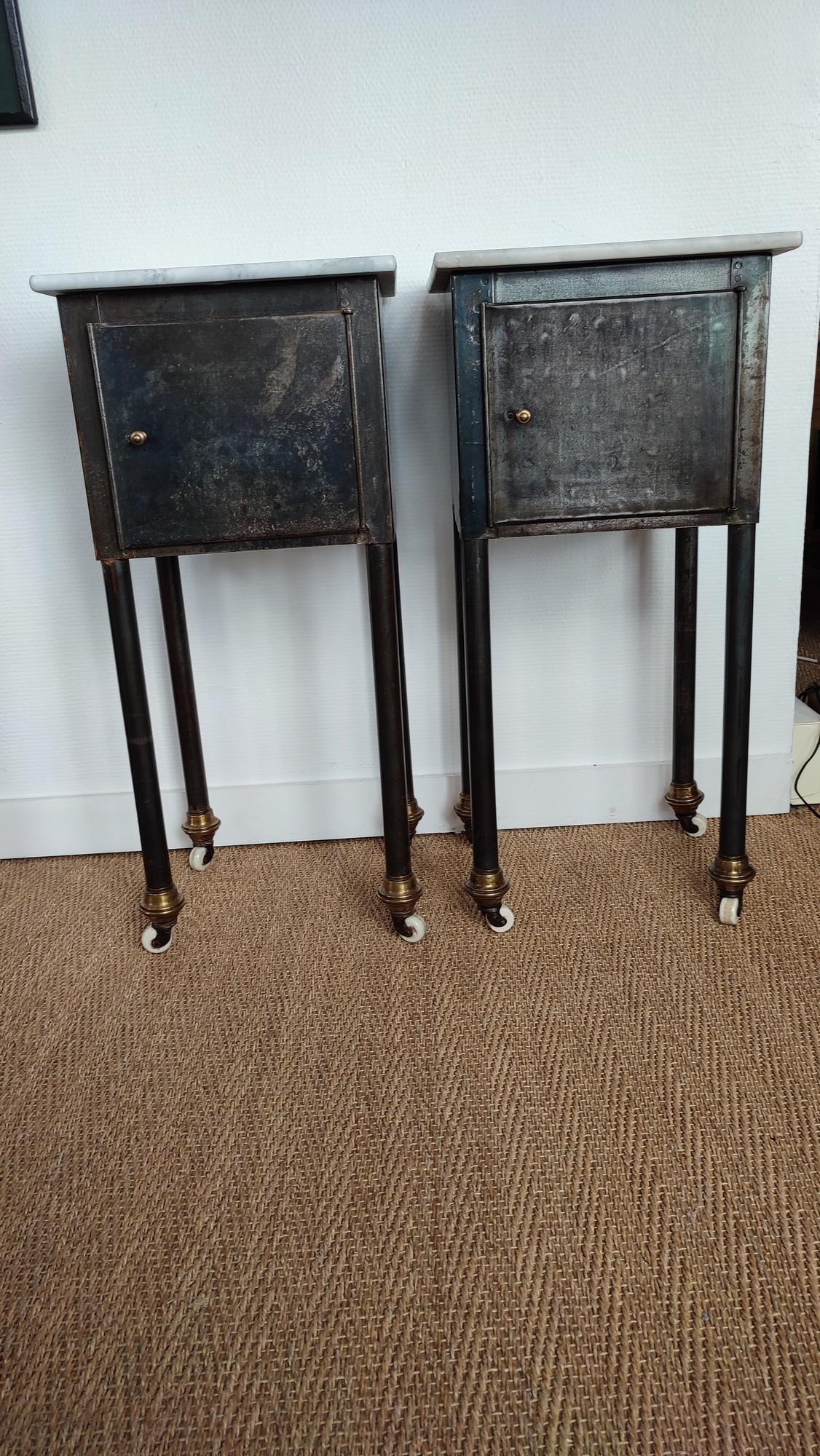 Pair of metal and marble tops night stands, early 20th Century, with ceramic wheels. The metal has been stripped and a coat of laquer has been applied.
One marble top has been repaired, see photo.
Nice metal colors and patina.