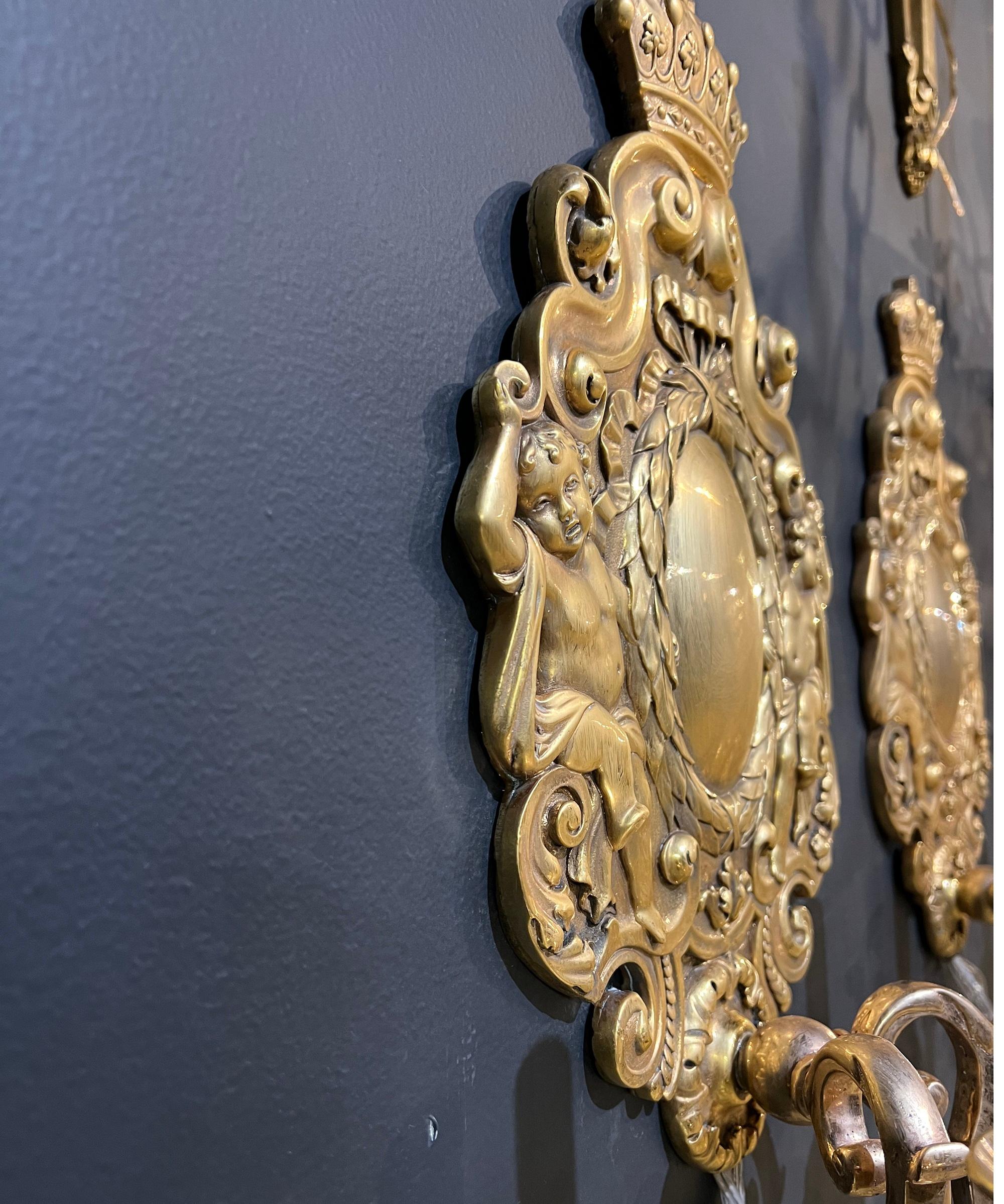 A circa 1900’s Caldwell gold plated sconces with cherubs and two lights