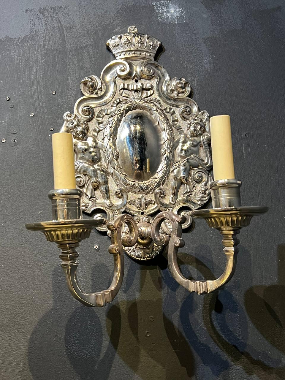 A circa 1900’s Caldwell silver plated sconces with cherubs and two lights