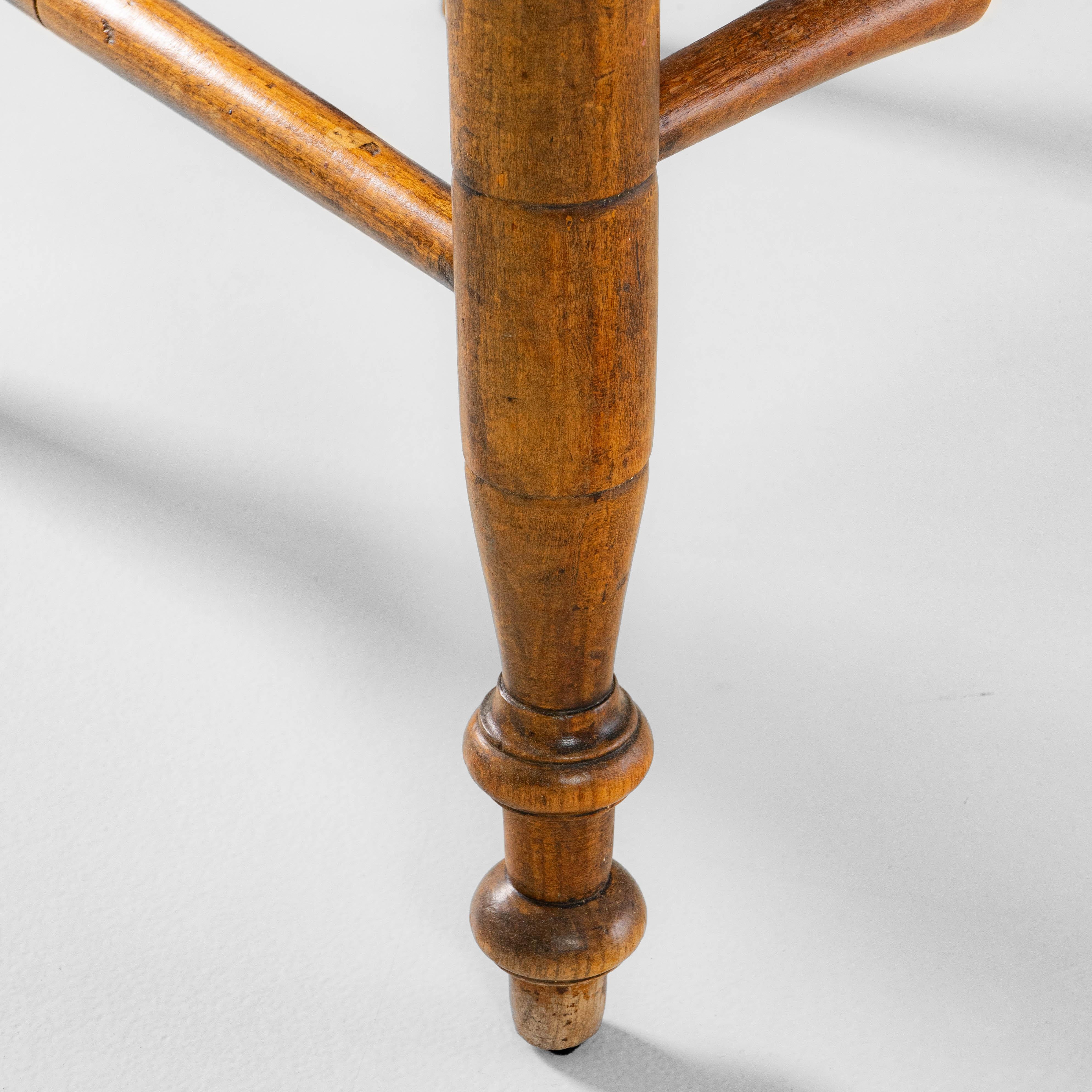 This pair of 1900s French Louis XIII wooden armchairs showcases the elegance and craftsmanship associated with the style, highlighted by beautifully preserved cane seats and backs. Each chair features turned wood detailing throughout, including the