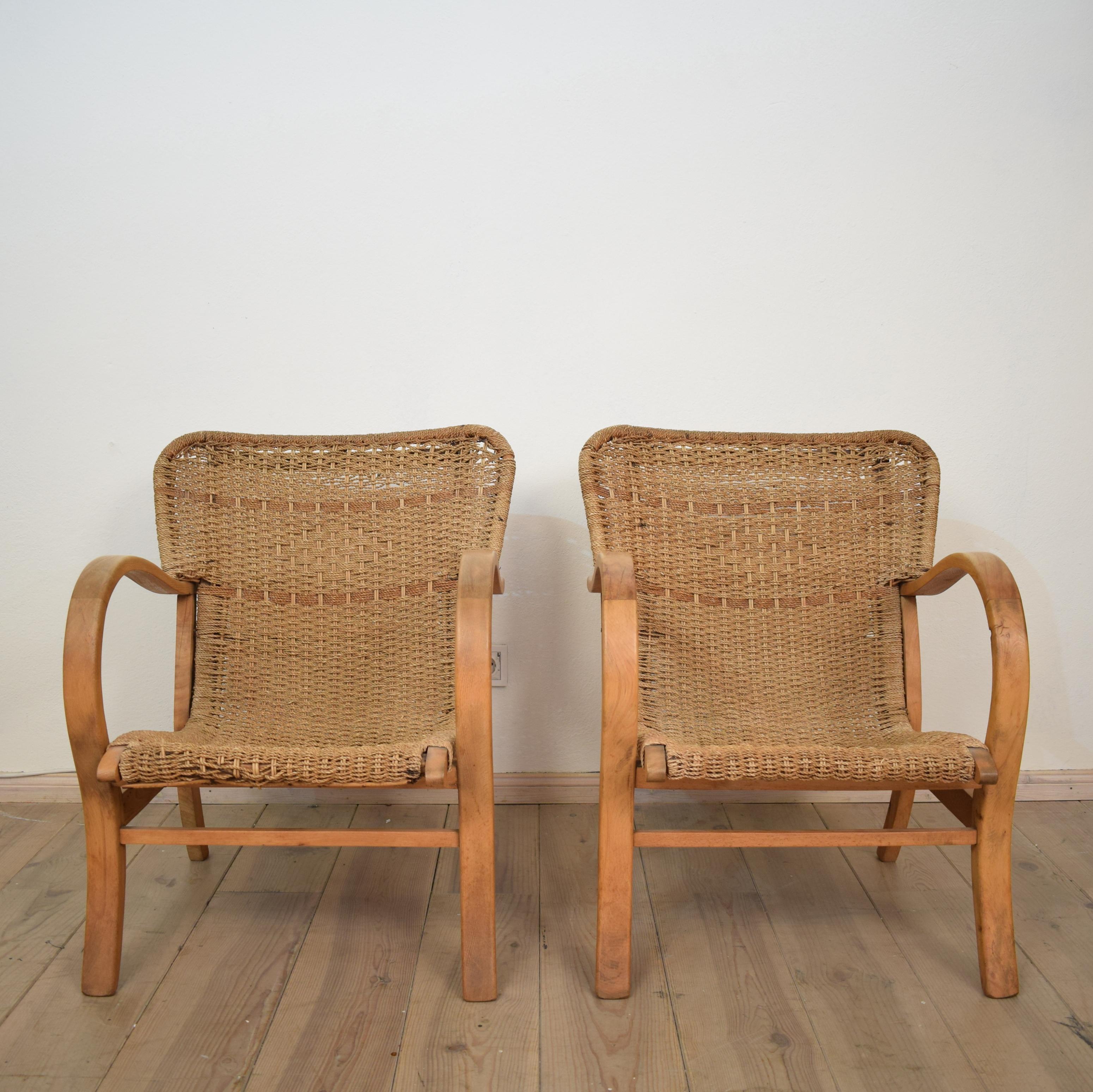 This unusual and rare version of a pair of 1920 armchairs / lounge chairs by Erich Dieckmann are in very good original condition. (Some small parts are a bit loose)
They are made out of beech and woven rope / cane.
A perfect match for your modern,