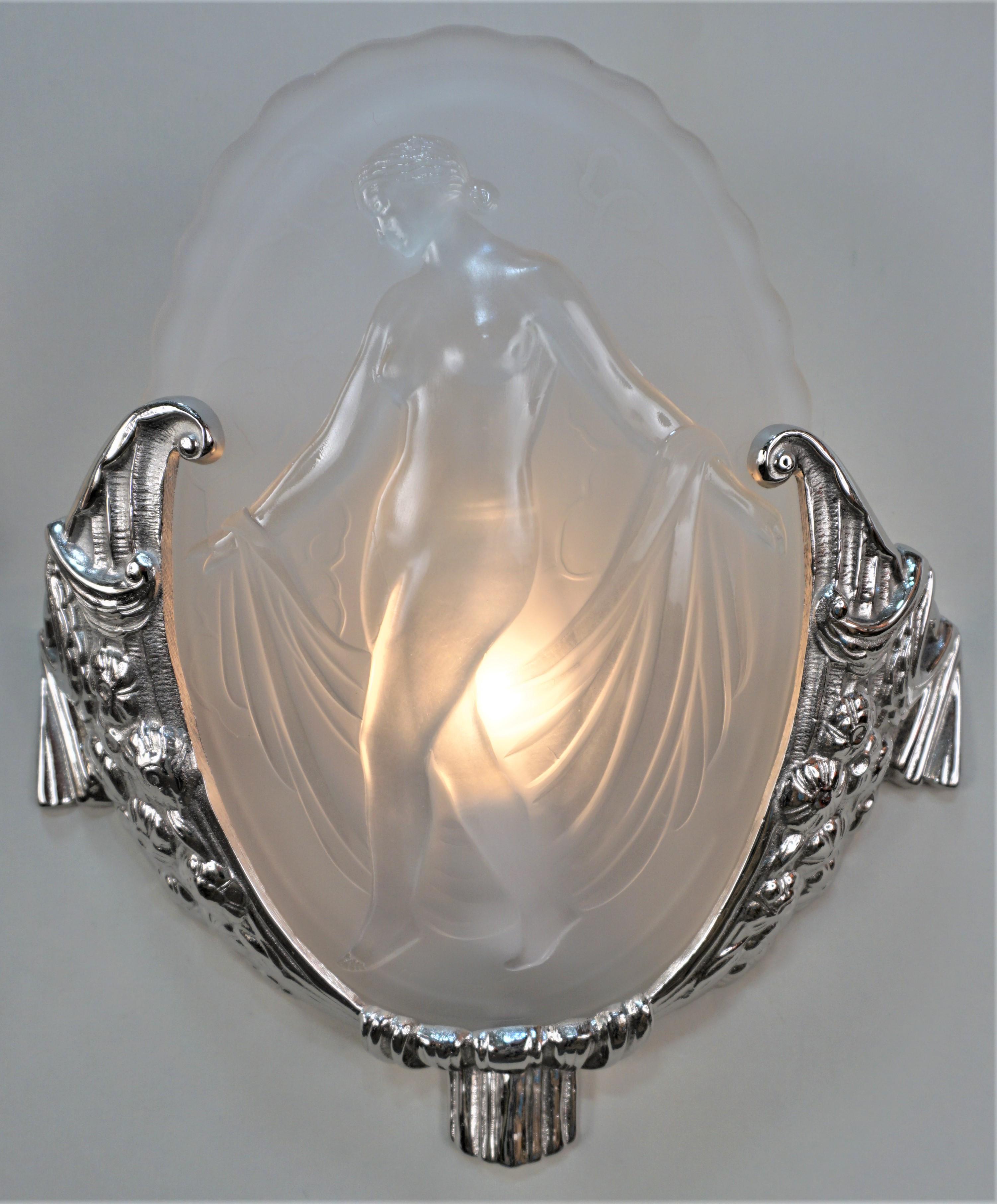Exquisite pair of Art Deco wall sconces by Muller Freres. Clear frost ovel shape with high light nude figure, each panel has different figure with beautiful high polished nickel on bronze frames.
Professionally rewired and ready for installation.