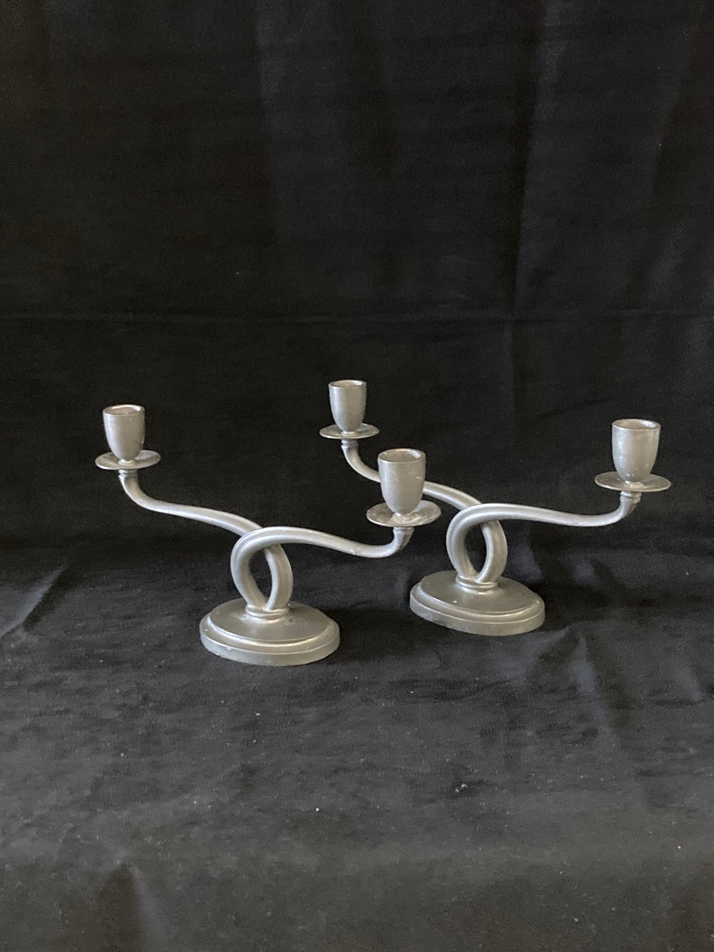 A pair of 1920s Arts and Crafts pewter candle holders designed by Just Andersen, Denmark.
The candle holders are in good vintage condition and marked with Just Andersen's triangle mark as well as with the model number - 1799.

Just Andersen