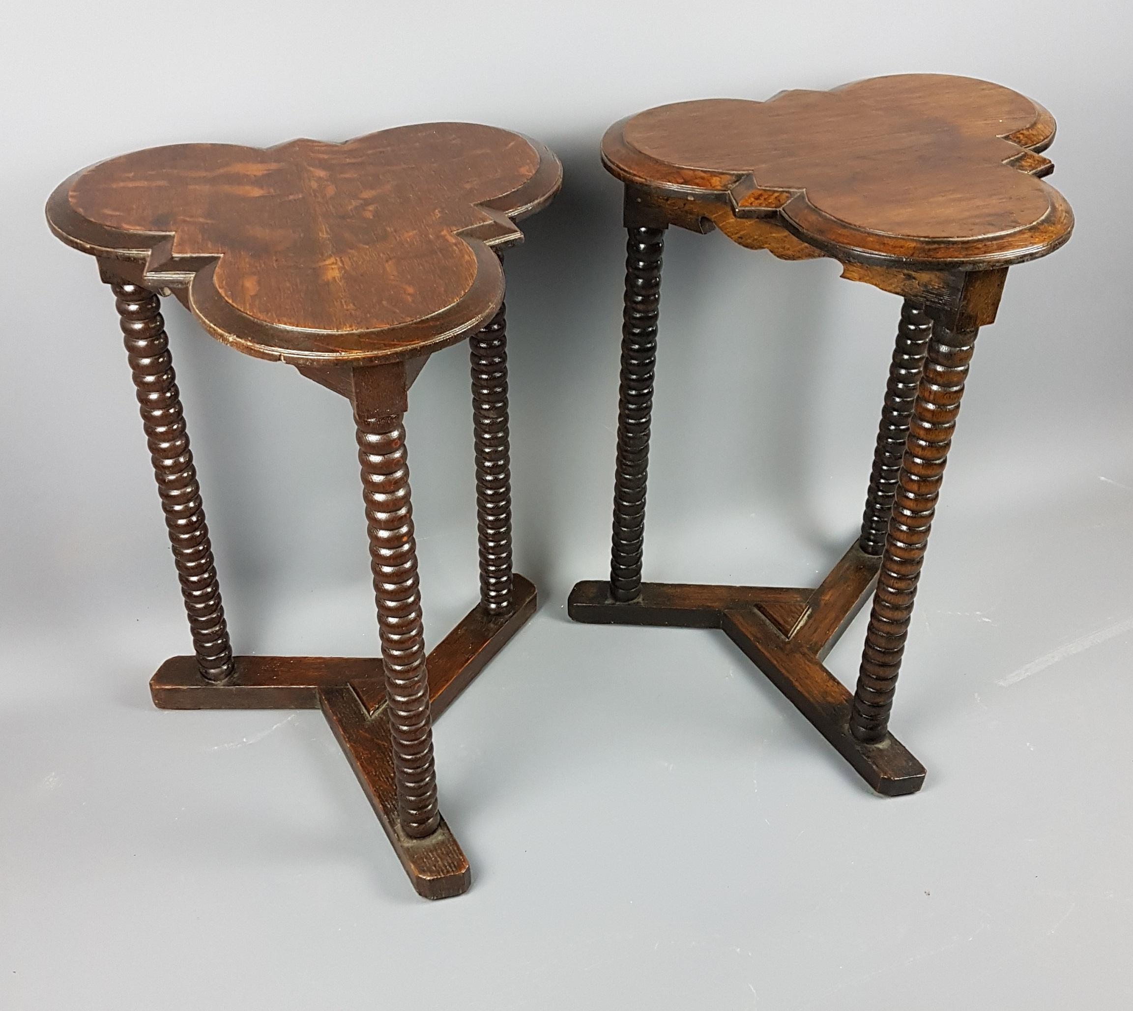A great pair of solid oak arts and crafts style bobbin turned tables with stylized cloverleaf tops to them and unusual tri-formed stretcher base. They are from the 1920s and for the tops they have used a great cut of the oak which shows off the