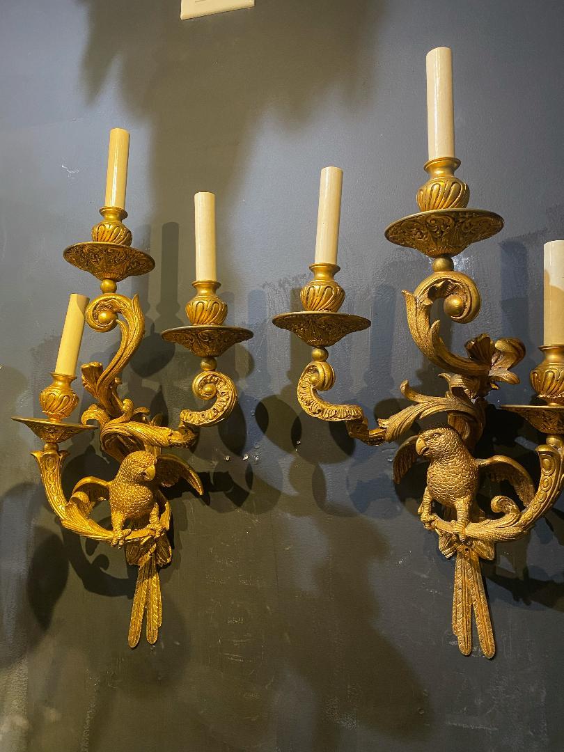 A pair of circa 1930’s French Bagues gilt bronze sconces with parrots design. Sconces with three lights 