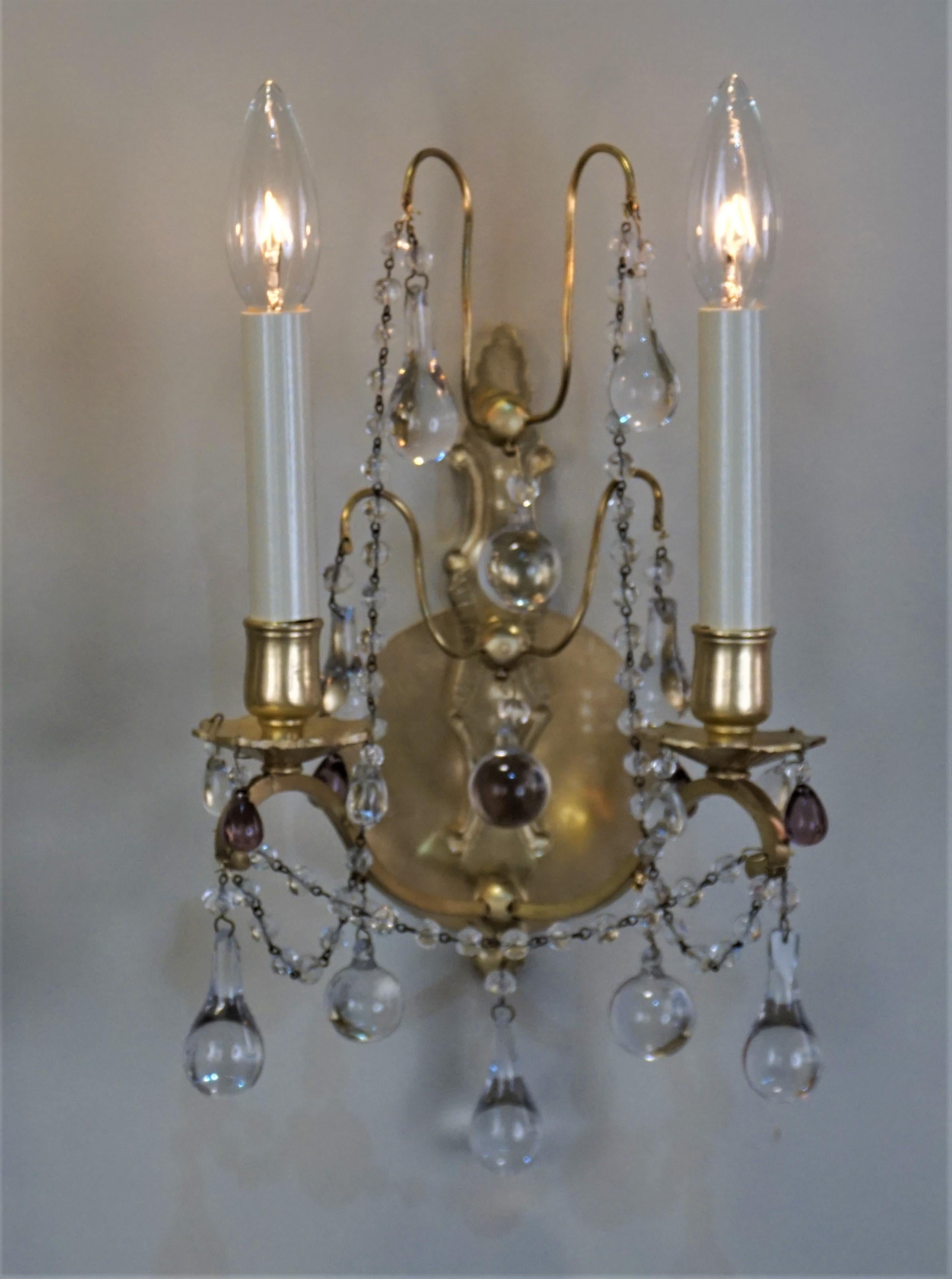 Pair of French 1930s crystal and bronze double arm wall sconces.