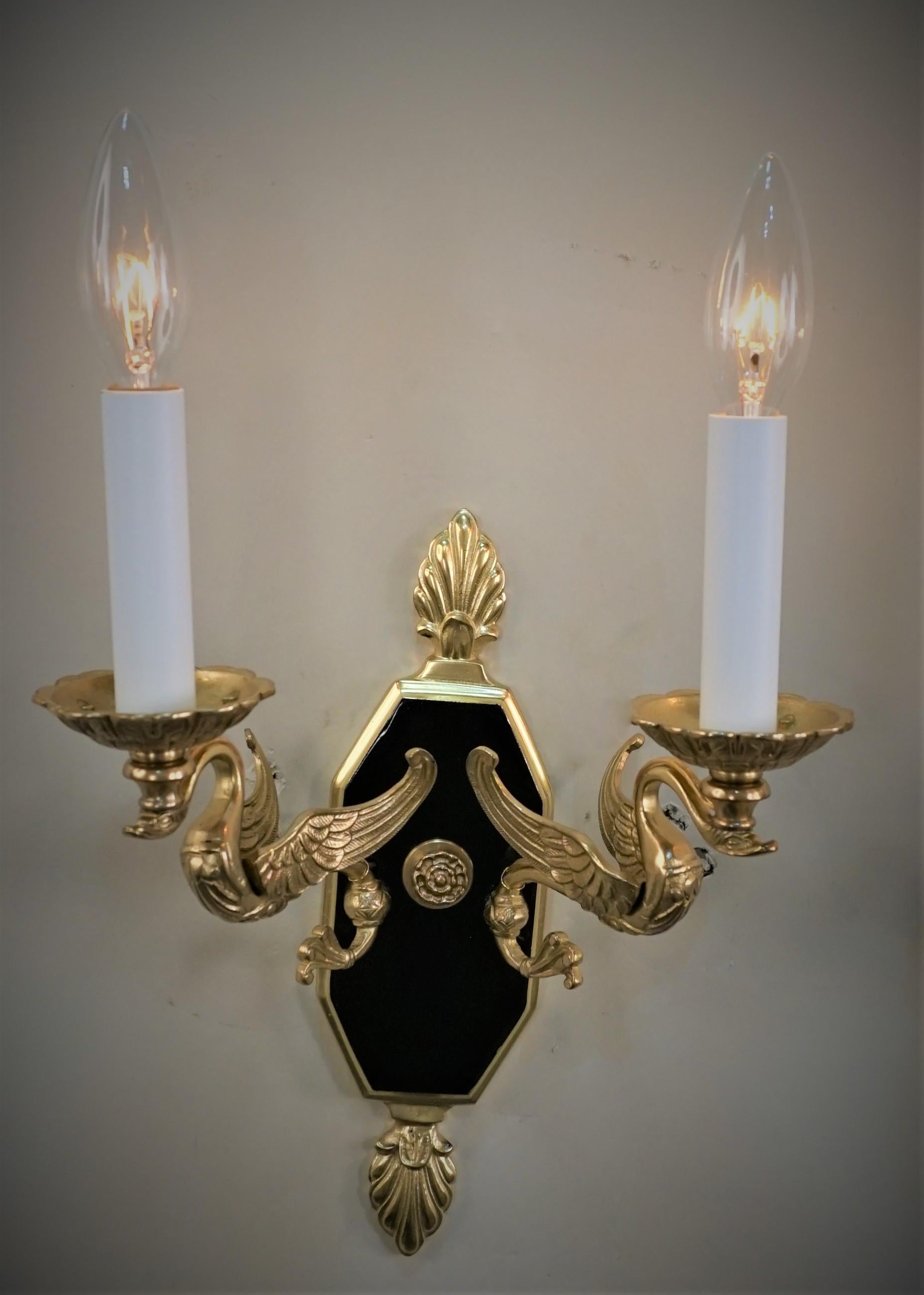Pair of 1920's swan arms empire style double arm bronze with black lacquer wall sconces.
Professionally rewired and ready for installation.
Bac plate measurement: height 10.25
