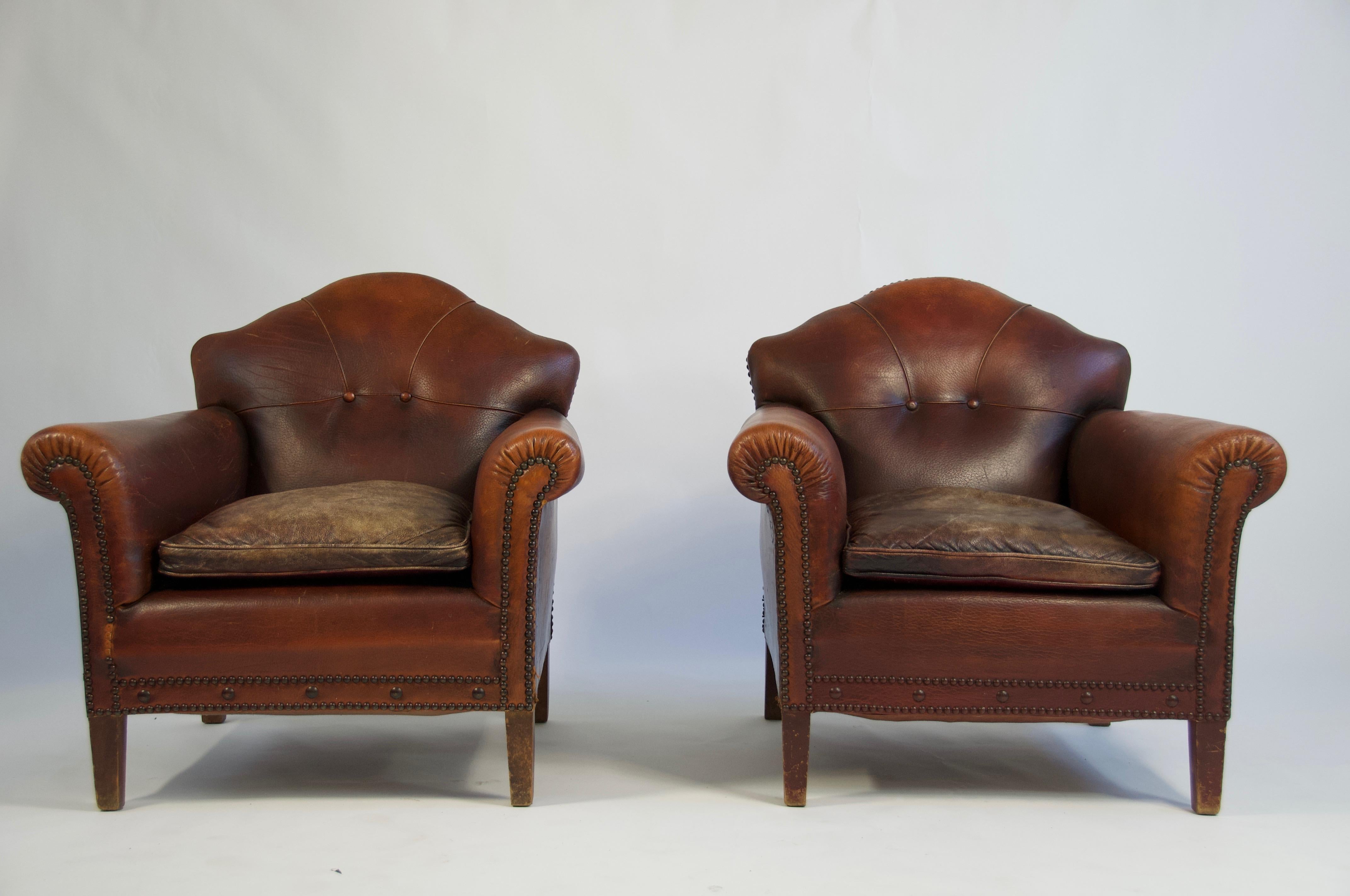 Pair of 1920s European leather lounge chairs.