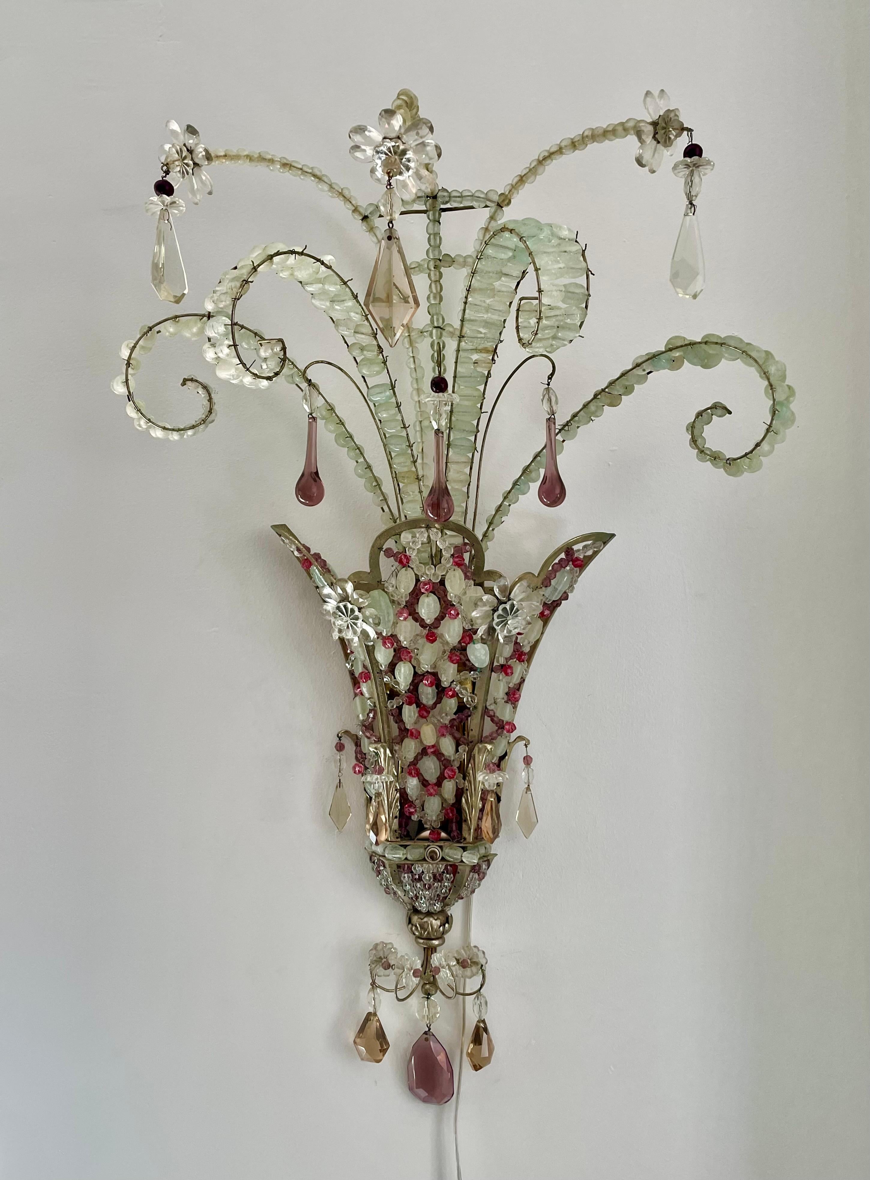 Madcap, whimsical, spritely, over-the-top -- these are just a few of the adjectives that spring to mind in describing this stylish pair of 1920s French sconces.  Their steel frames are silvered, strewn with crystal prisms and cut-and-blown-glass