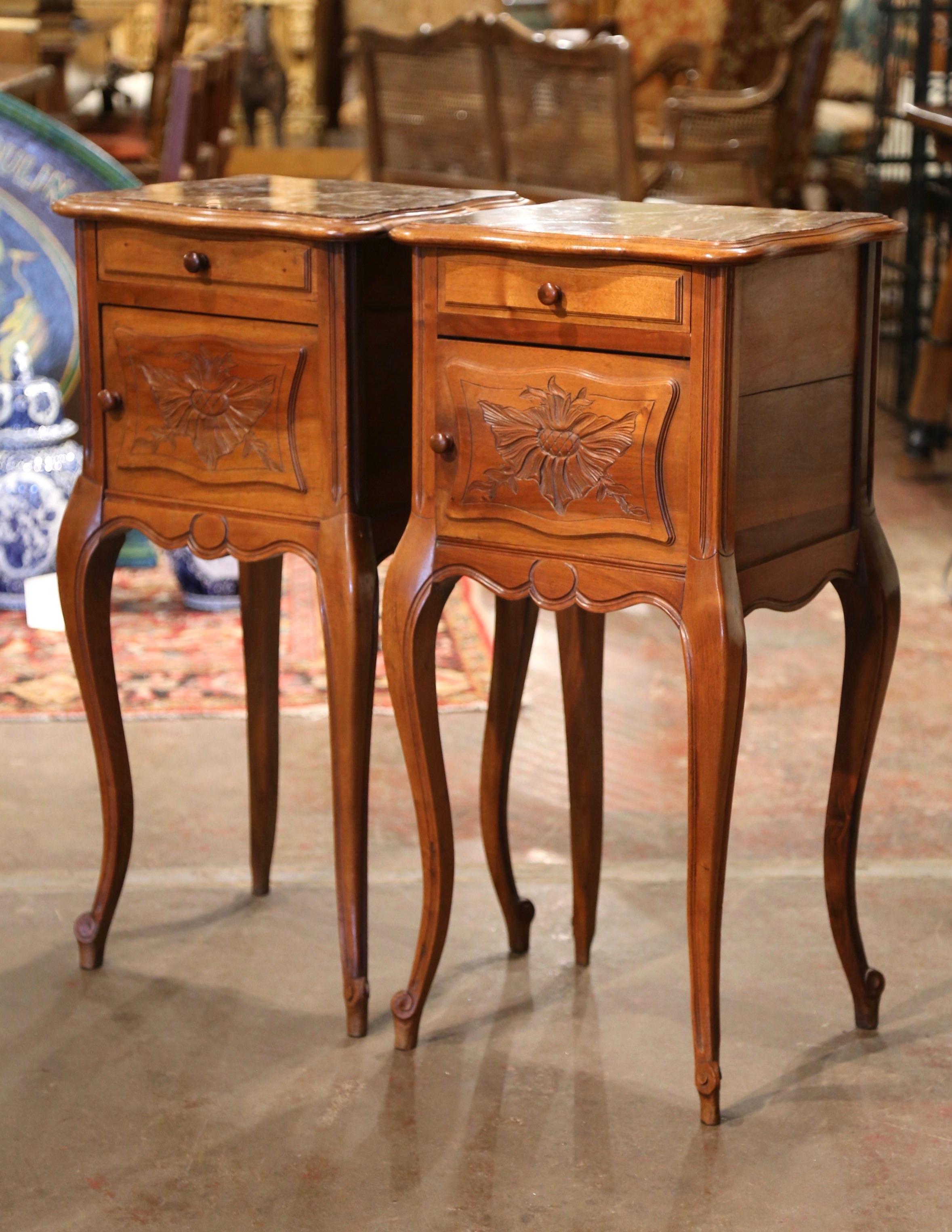 These elegant antique bedside tables were created in France, circa 1920. Almost square in shape, the fruitwood chests stand on cabriole legs ending with escargot feet over a scalloped apron. Each cabinet is fitted with a top drawer dressed with a