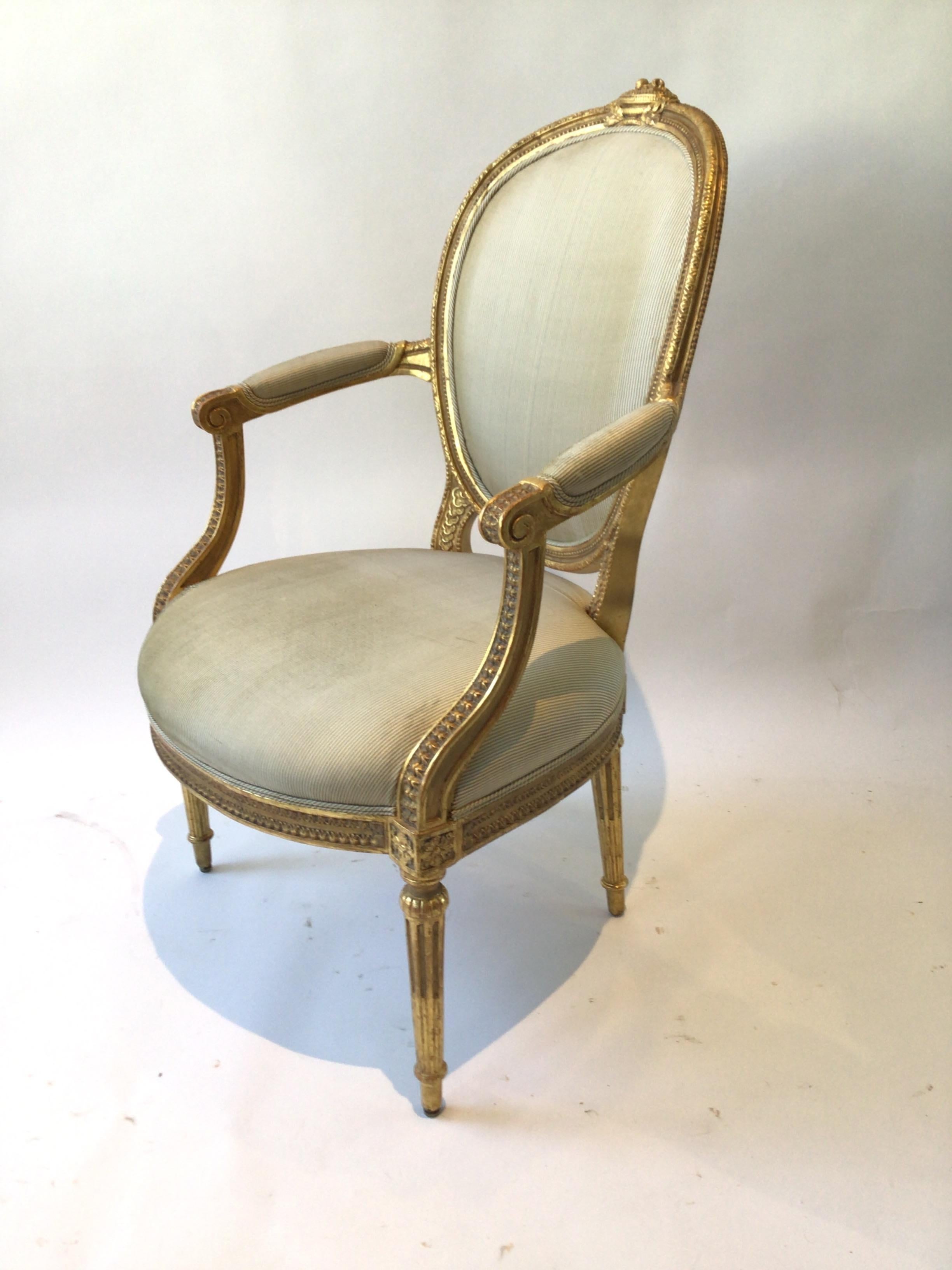 Early 20th Century Pair of 1920s Louis XVI French Carved Wood Gilt Armchairs