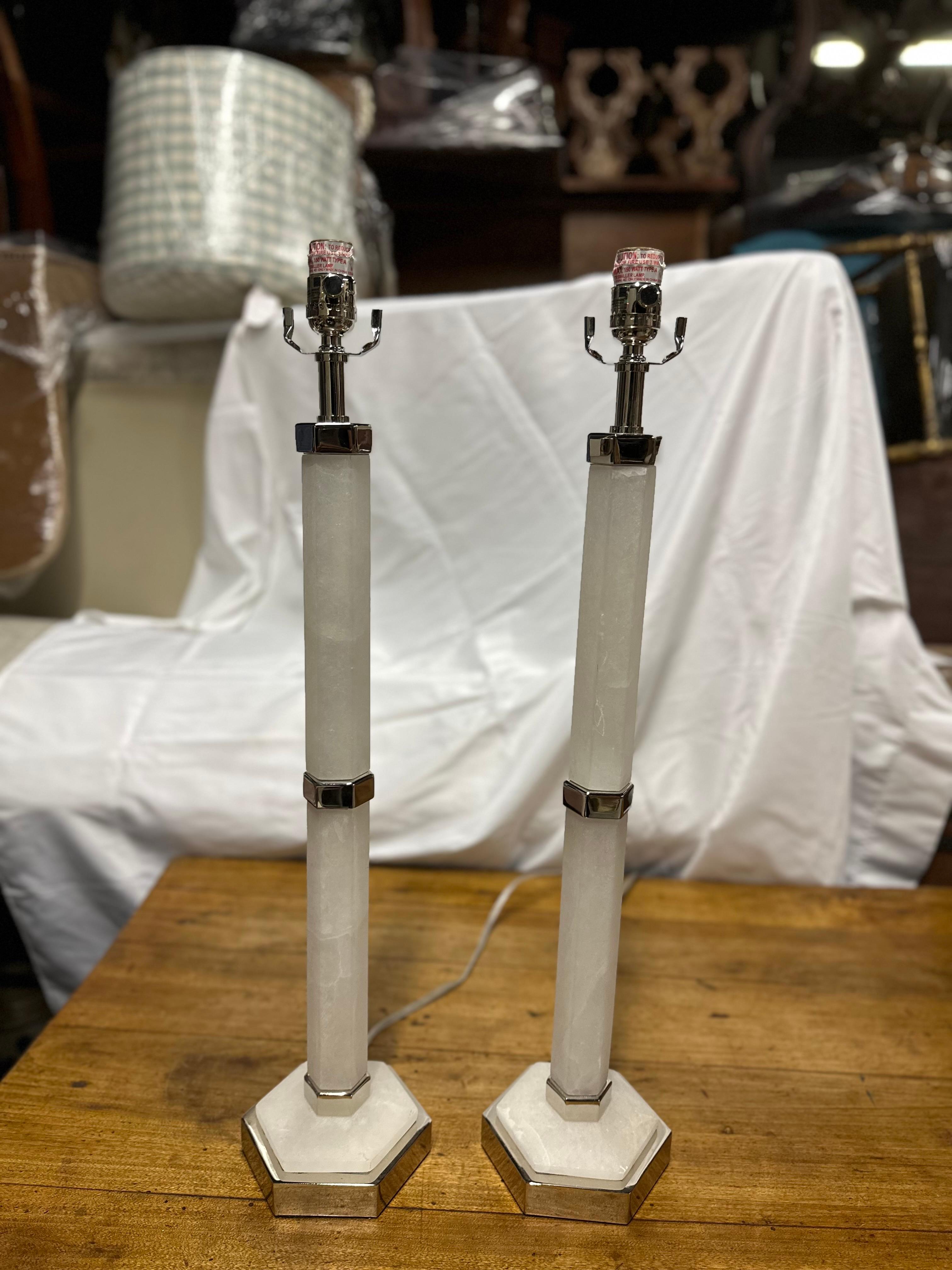 This pair of 1920's marble lamps epitomizes the Art Deco era's sleek elegance and refined craftsmanship. Standing tall and commanding attention, these lamps boast a timeless allure that effortlessly enhances any interior space. The marble