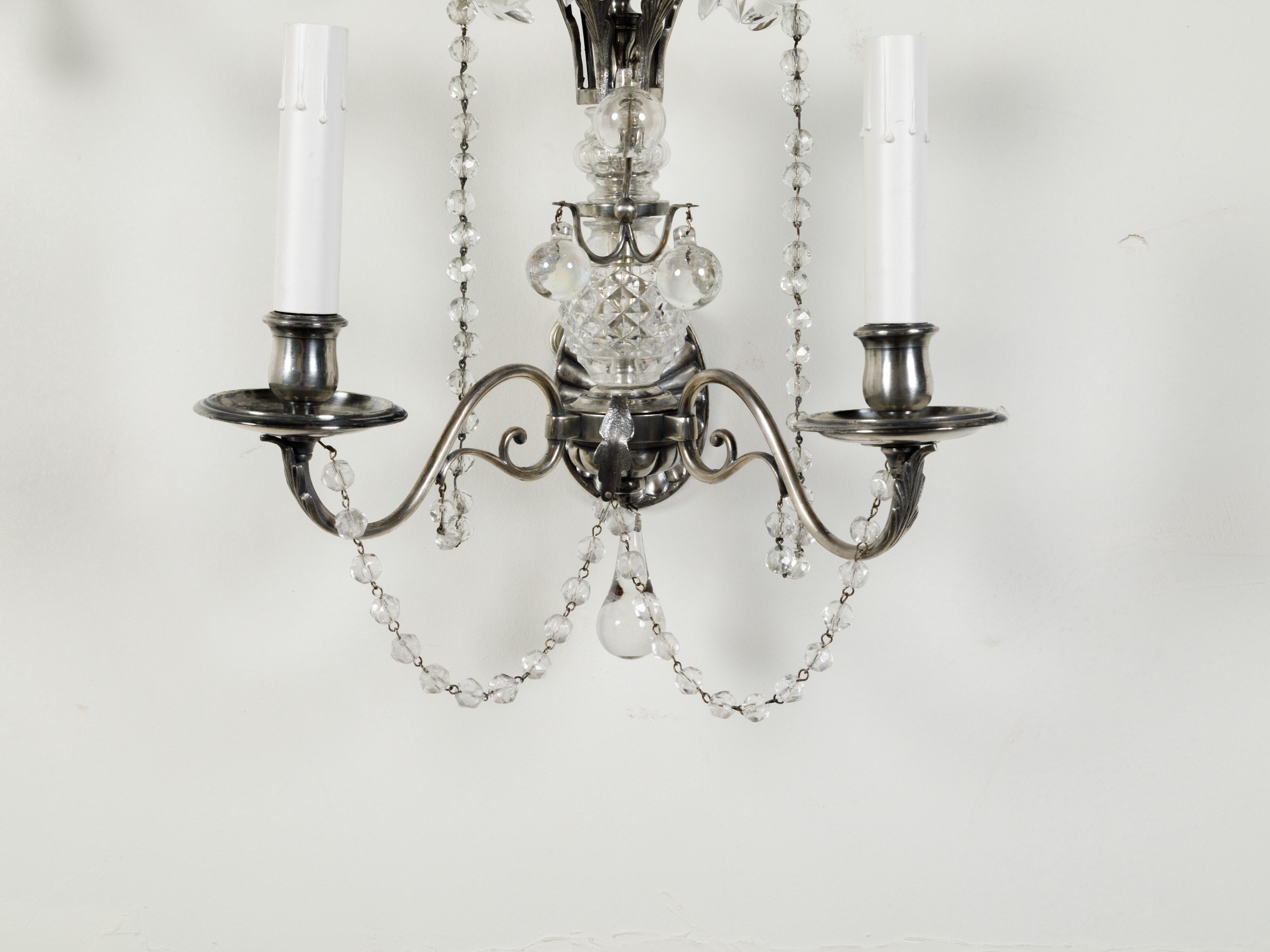Pair of 1920s Metal and Crystal Two-Arm Wall Sconces with Beads and Rosettes In Good Condition For Sale In Atlanta, GA