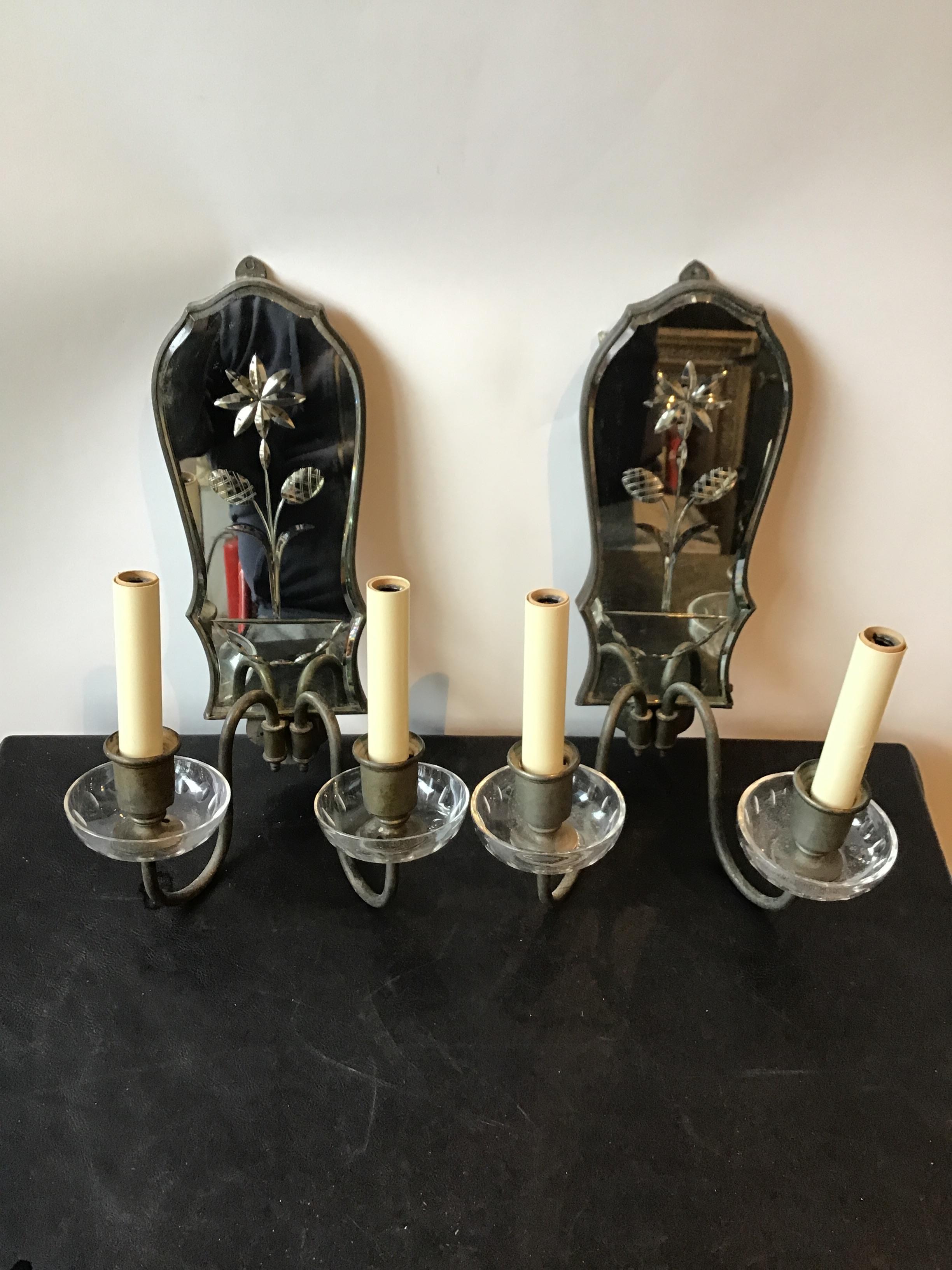 Pair of 1920s mirrored sconces. Flower in urn.