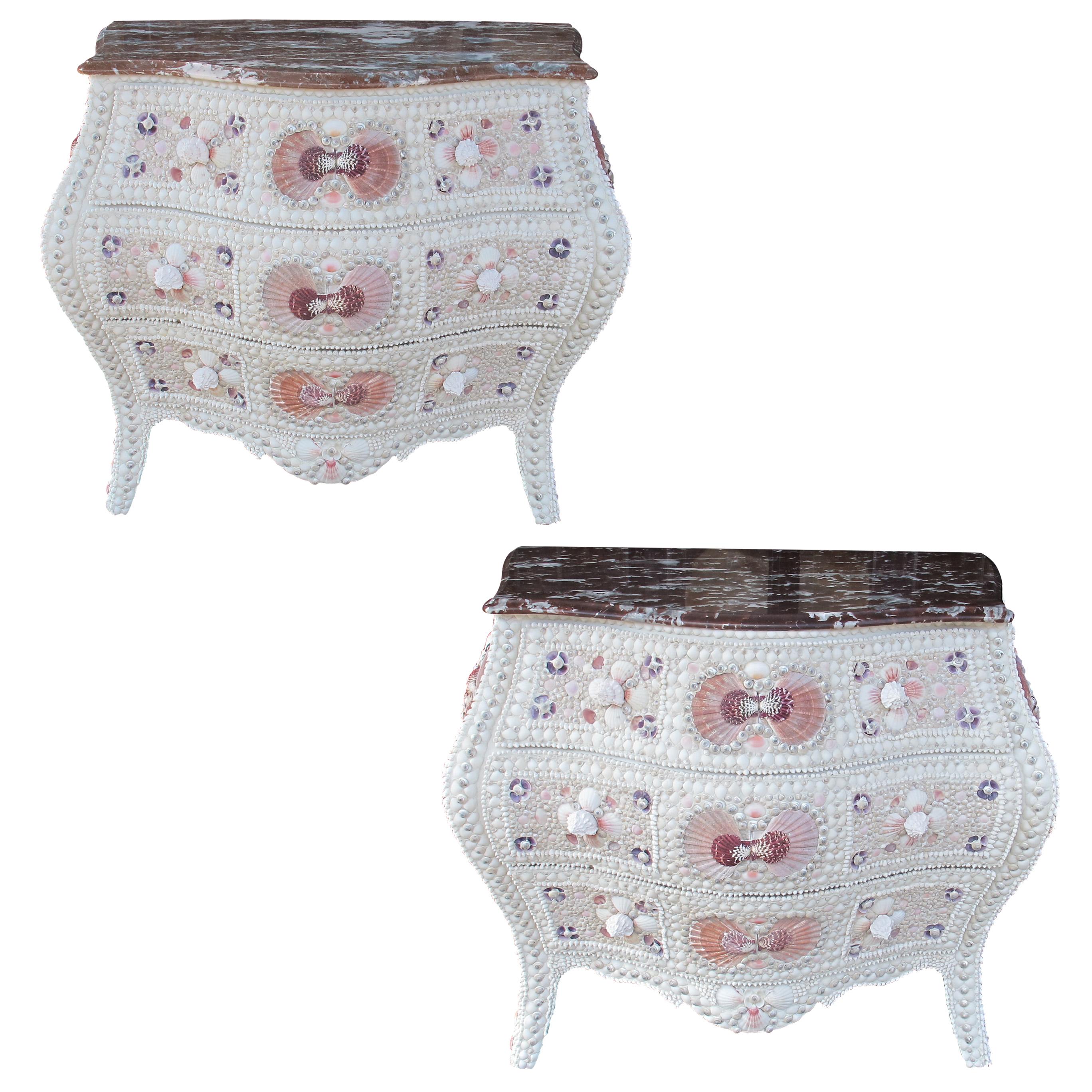A rare and captivating pair of 1920s Swedish bombe chests of drawers, each featuring three gracefully curved drawers and Rosso Levanto marble tops.  The chests of drawers boast voluptuous silhouettes and cabriole legs in the style of classic Rococo