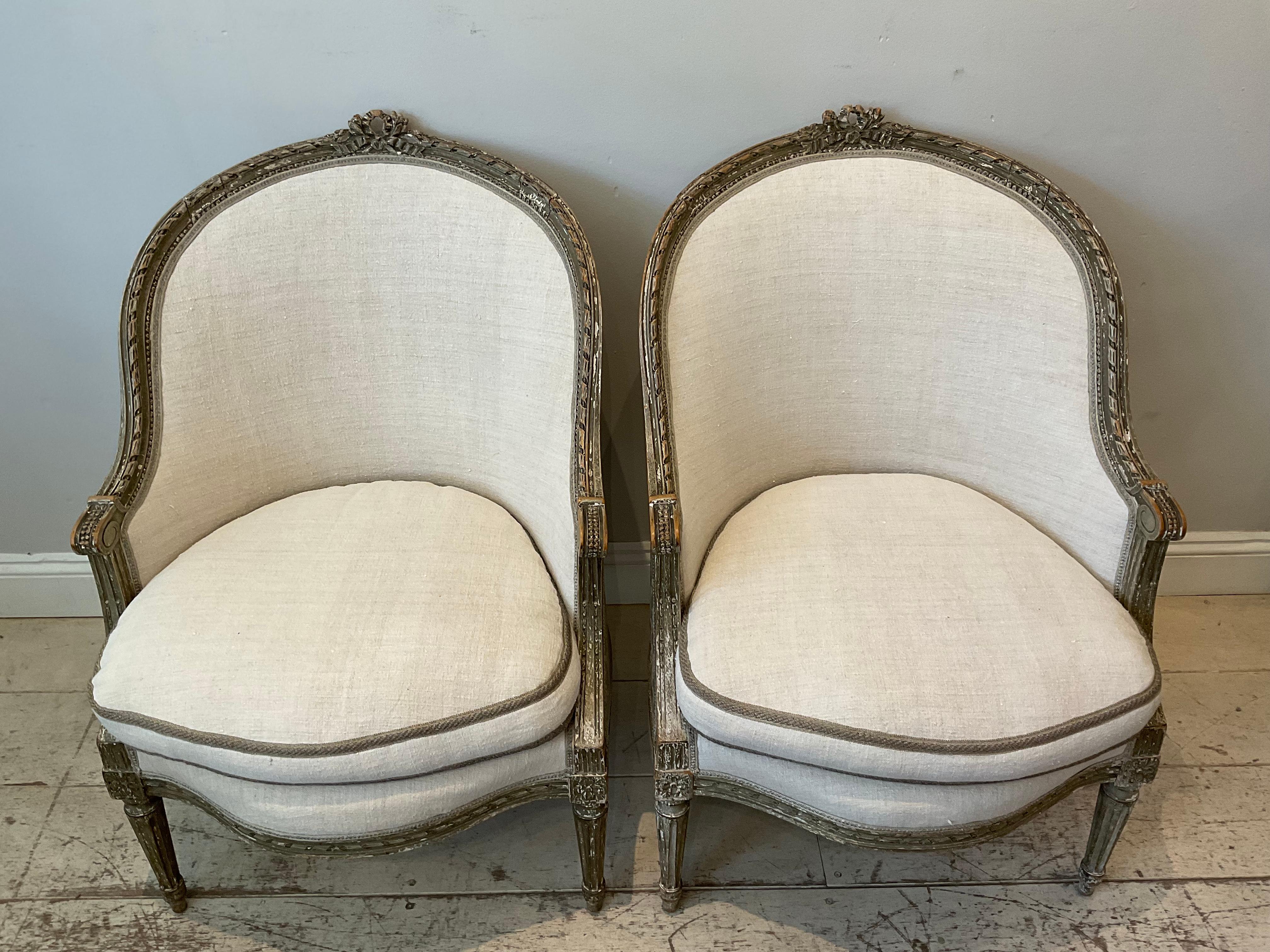 A charming pair of Swedish armchairs in the French style circa 1920s.

These lovely good quality chairs retain much of the original paint and their original fabric on the back.
The front has been reupholstered with a pale vintage French linen,