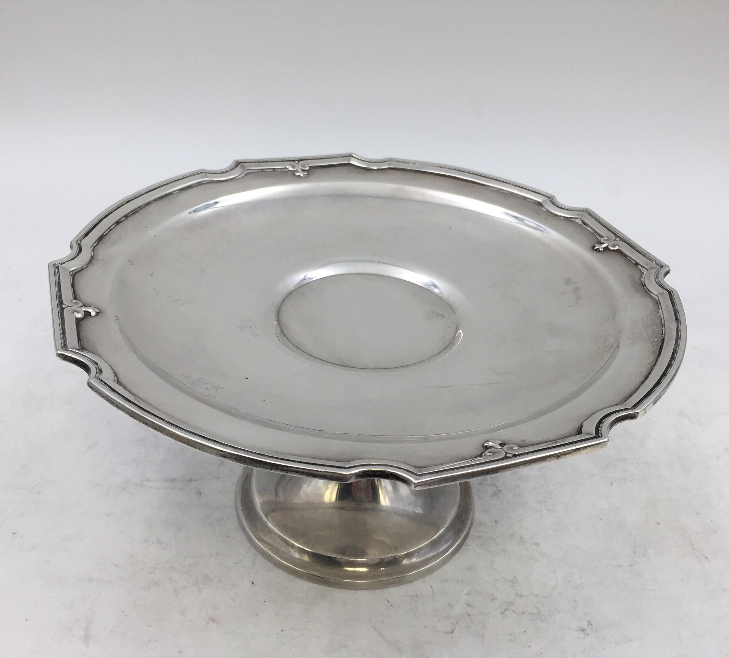 Sterling silver compote / footed centerpiece dish from 1927 by Gorham and Whiting, a Gorham subsidiary, with beaded and fleur-de-lys designs across the rims in King Albert pattern measuring 9'' in diameter and 4 2/3'' in height and weighing 29.4