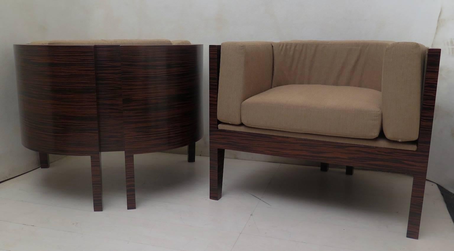 Pair of Italian Art Deco armchairs. All veneered in zebrano wood. Composed of a large wooden structure that runs all around the seat, and a series of cushions placed all around the backrest. Even the seat has a cushion with the same upholstery.
