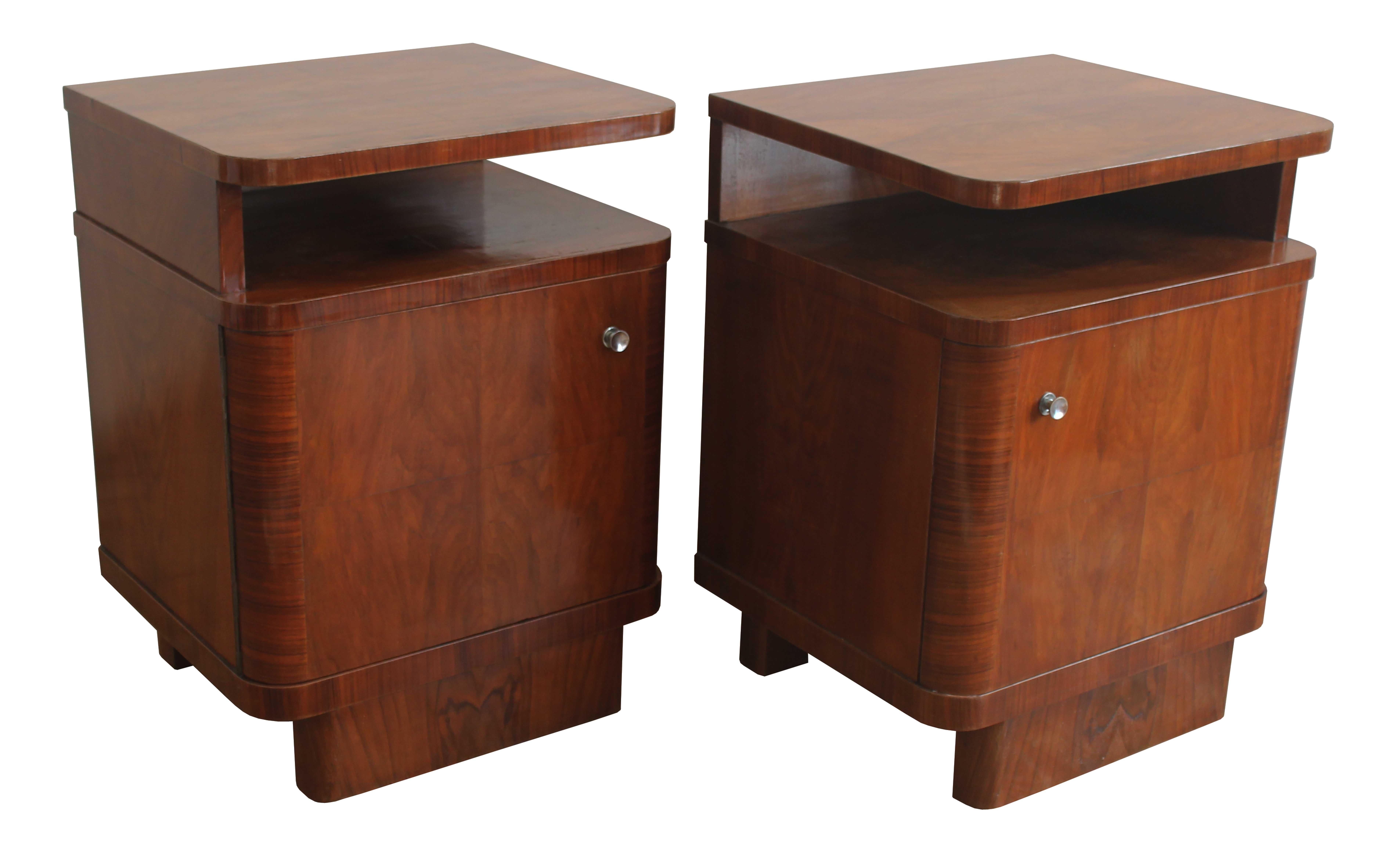 A pair of 1930’s Bedside tables made of Beech with a rich Walnut veneer texture.

There were many variations of this popular piece of furniture; it was an essential item for every stylish bedroom of the time.

This pair has got a wonderful