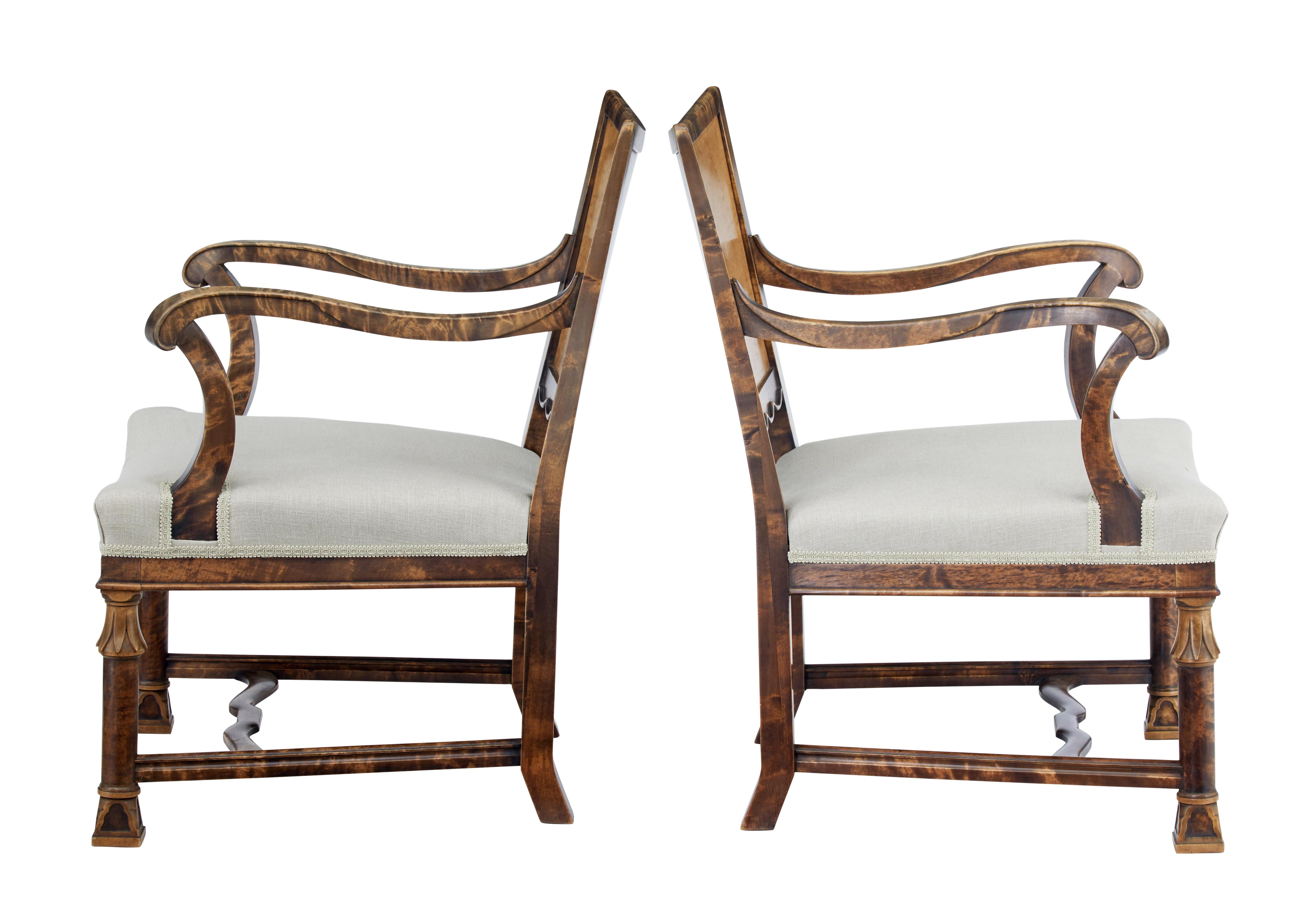 Beautiful pair of Art Deco period Swedish armchairs, circa 1930.

Shaped backs with inlaid walnut fleur de lis in the lower back panel. Scrolled arms with carved detail to the sides. Recently upholstered in plain fabric with braid edging. Standing