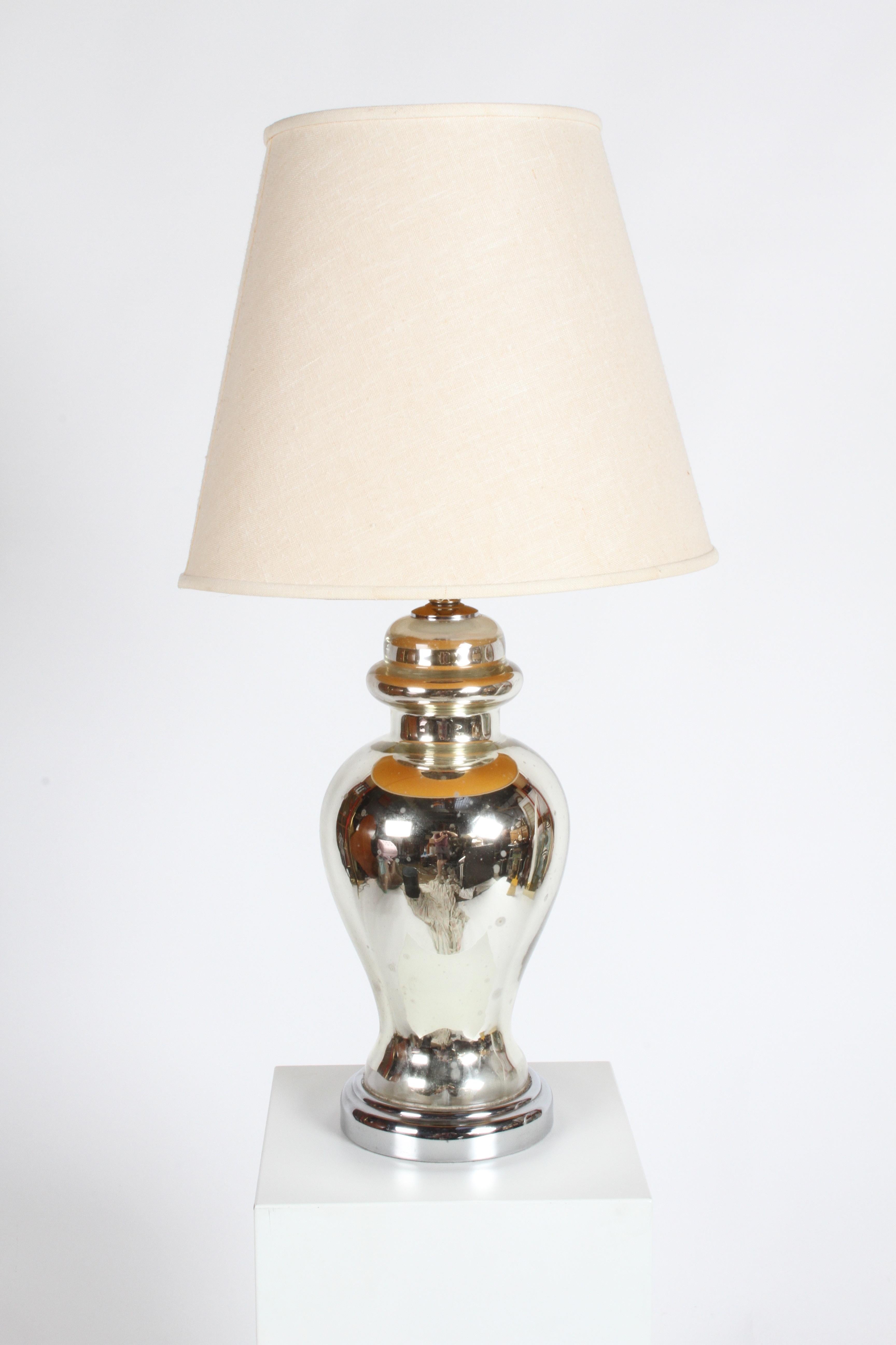 Pair of French Hollywood Regency bulbous or urn form mercury lamps on chrome bases. They have some age spotting. Lots of reflections, hard to capture. Shades not included. Will be rewired prior to shipping. Base is 7