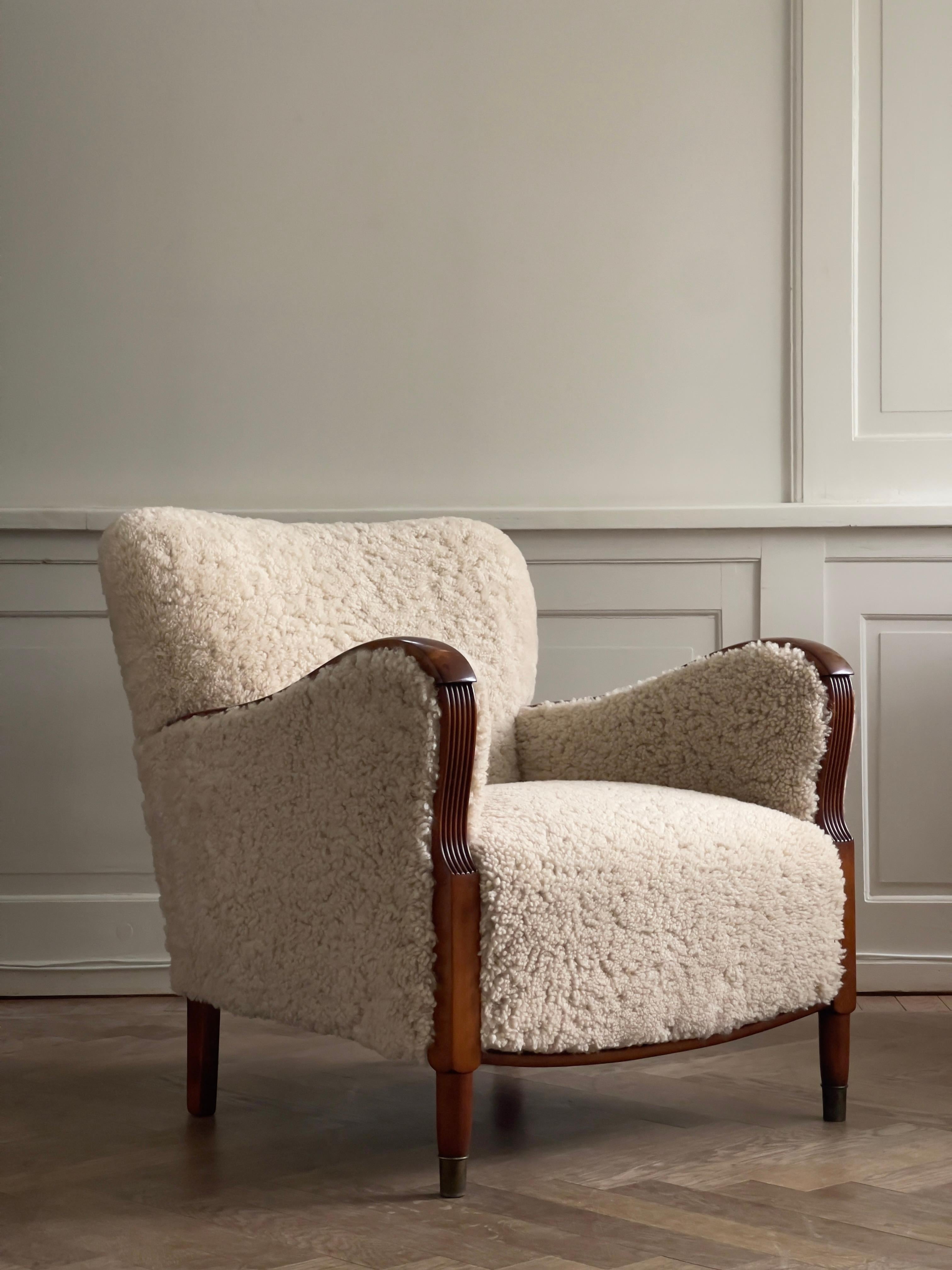 Scandinavian Modern Pair of 1930s Art Deco danish lounge chairs reupholstered in natural sheepskin. For Sale