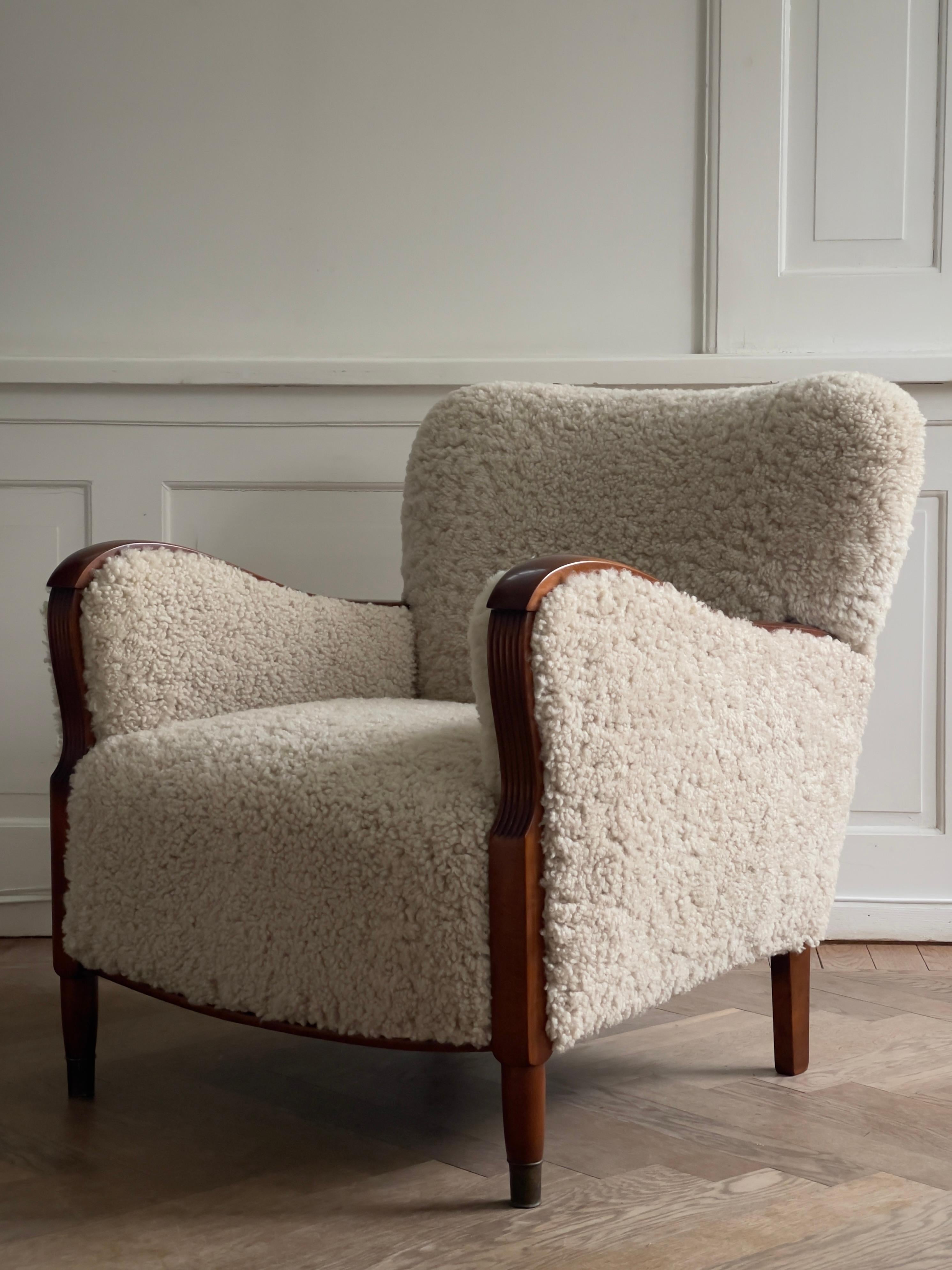 Hand-Crafted Pair of 1930s Art Deco danish lounge chairs reupholstered in natural sheepskin. For Sale