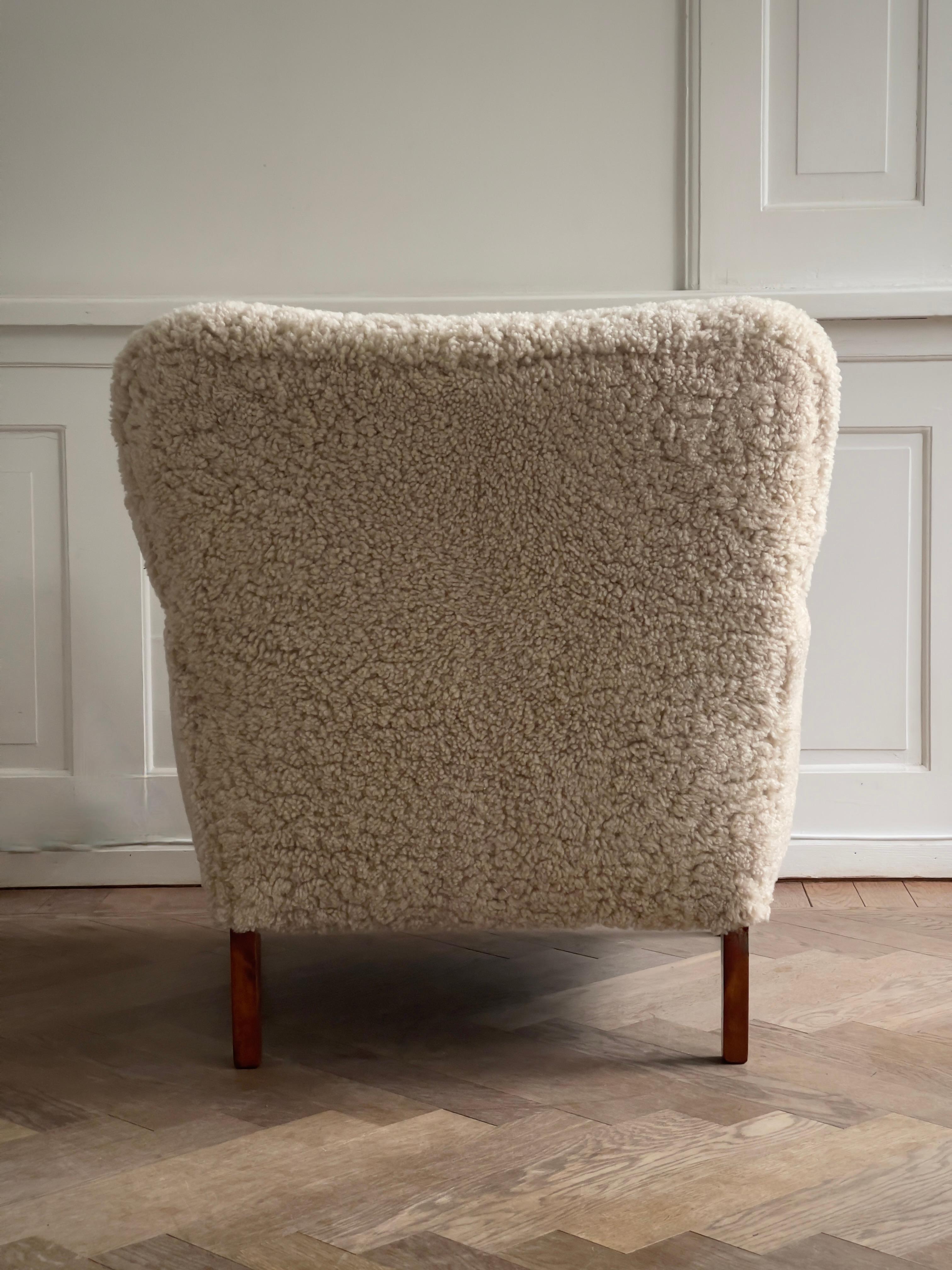 Beech Pair of 1930s Art Deco danish lounge chairs reupholstered in natural sheepskin. For Sale
