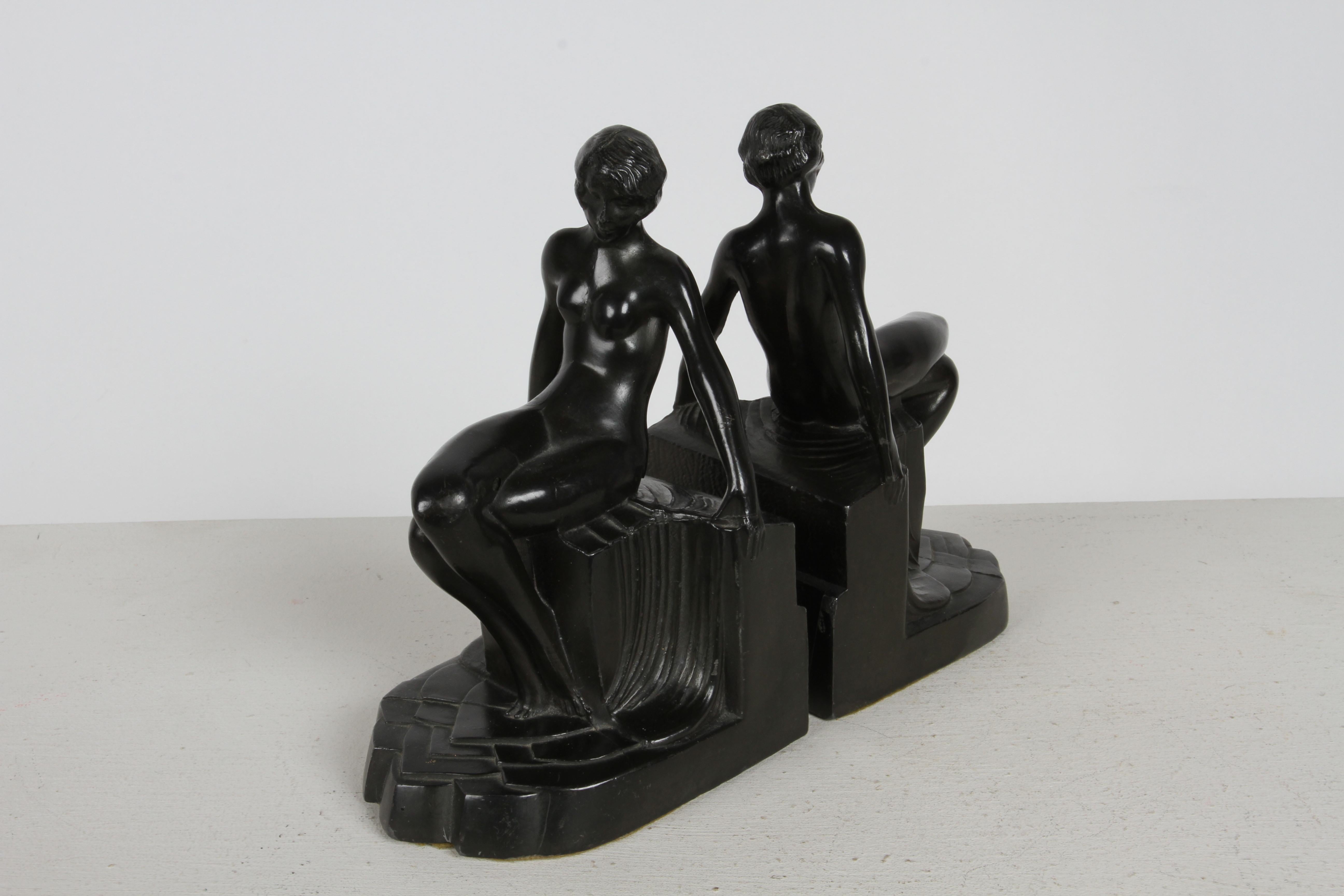 Original pair of highstyle Nuart NYC, c.1930s Art Deco nude flapper girl spelter metal bookends with original black paint. Features a women sitting on a pedestal in the nude. Felt bottoms, weighted. 

Key Words :
Max Le Verrier
Demetre