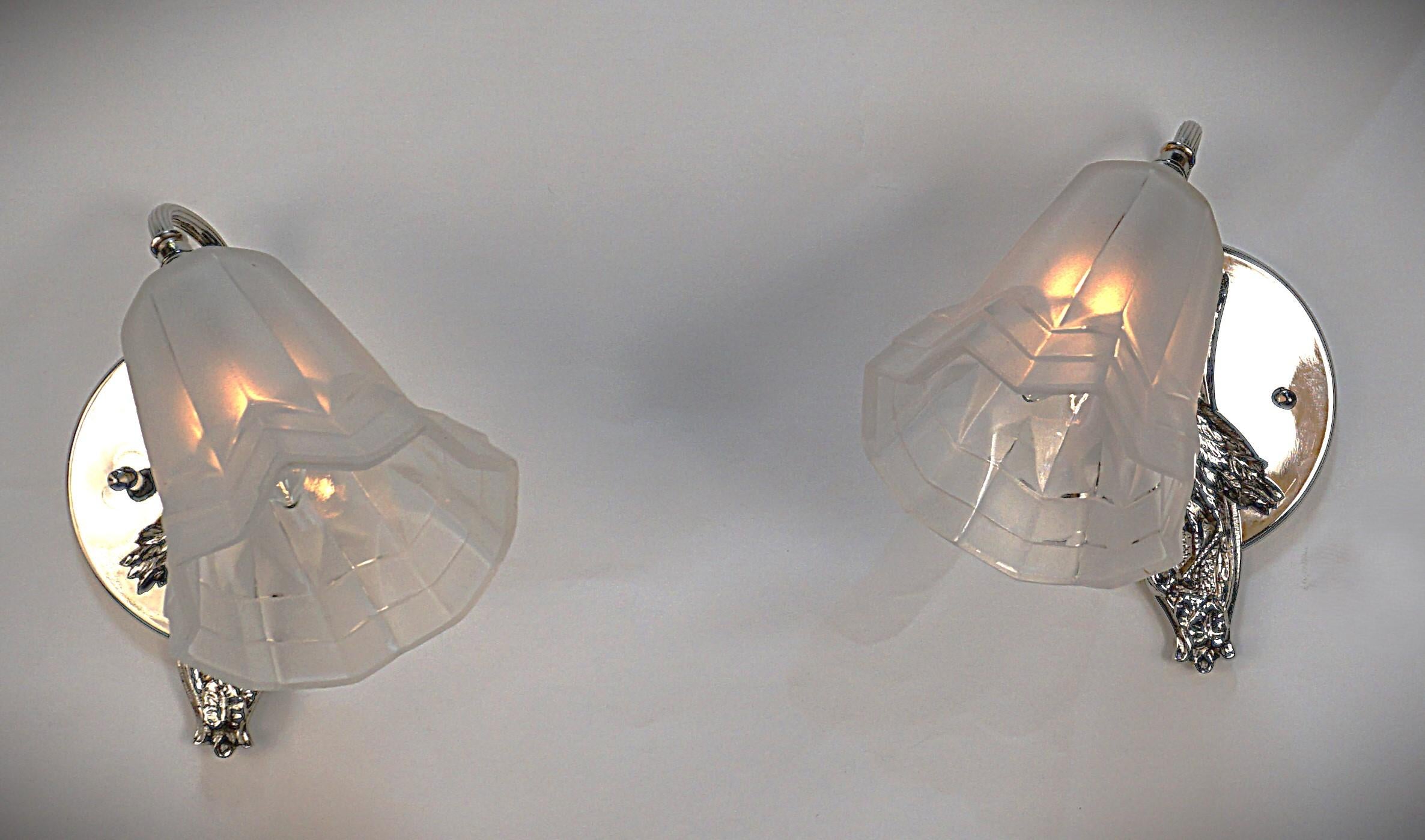 Pair of polished nickel on bronze bird design with clear frost glass shades.
Professionally rewired and ready for installation.