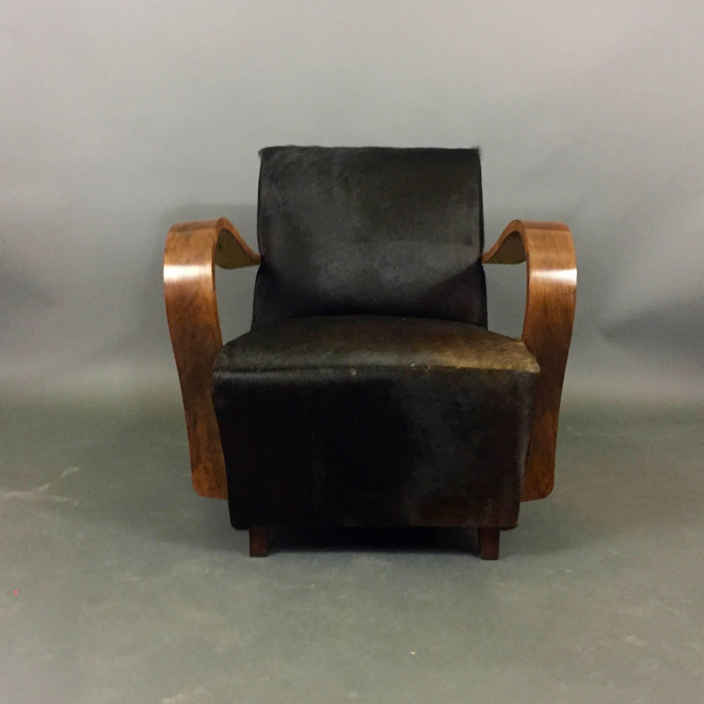 We are uncertain of the origin of this pair of lounge chairs - though think Austria in the 1930s likely possibility - and purely in the Art Deco tradition with wide sweeping and curved-arms, beautifully refinished. Recent luxe black cowhide