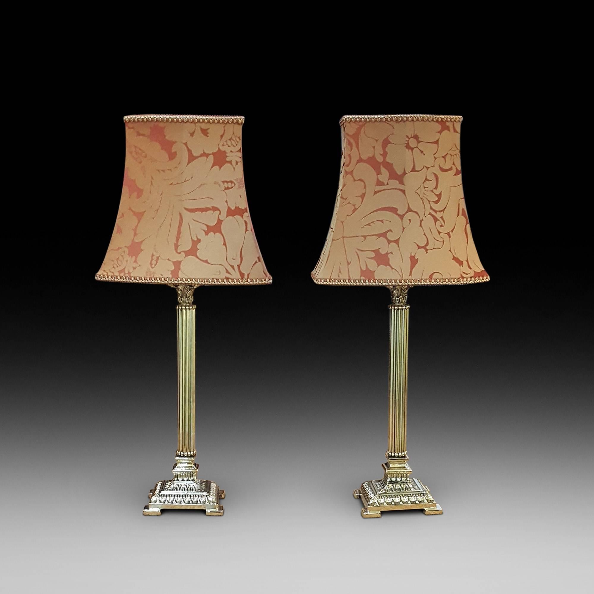 Pair of 1930s brass Corinthian column table lamps. The lampshade(s) are newly handmade silks by the same maker as provides the shades for Downton Abbey - all lights and lamps have been rewired with authentic corded flex, fitted with either foot