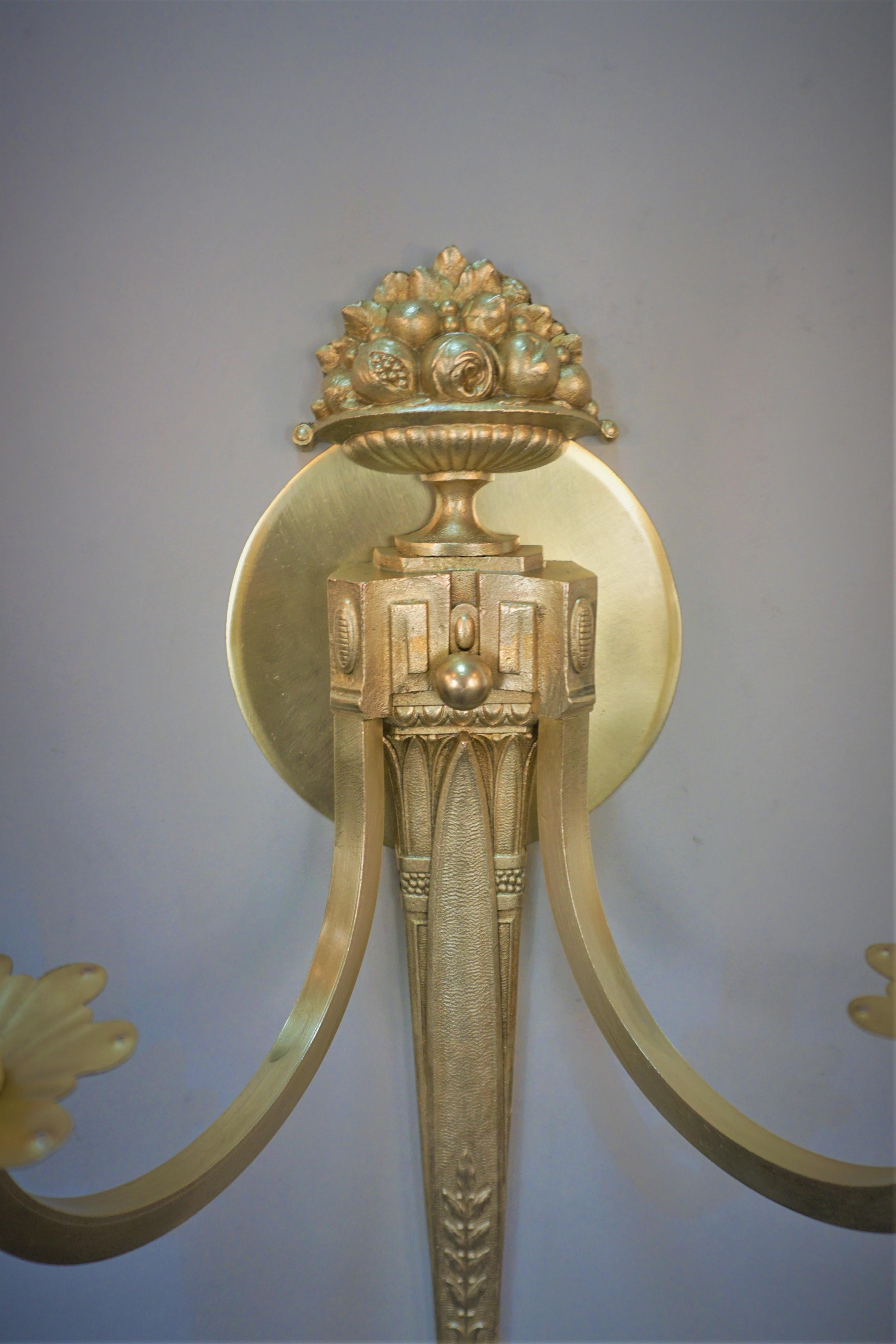 Pair of 1930's double arm bronze wall sconces in classic design.