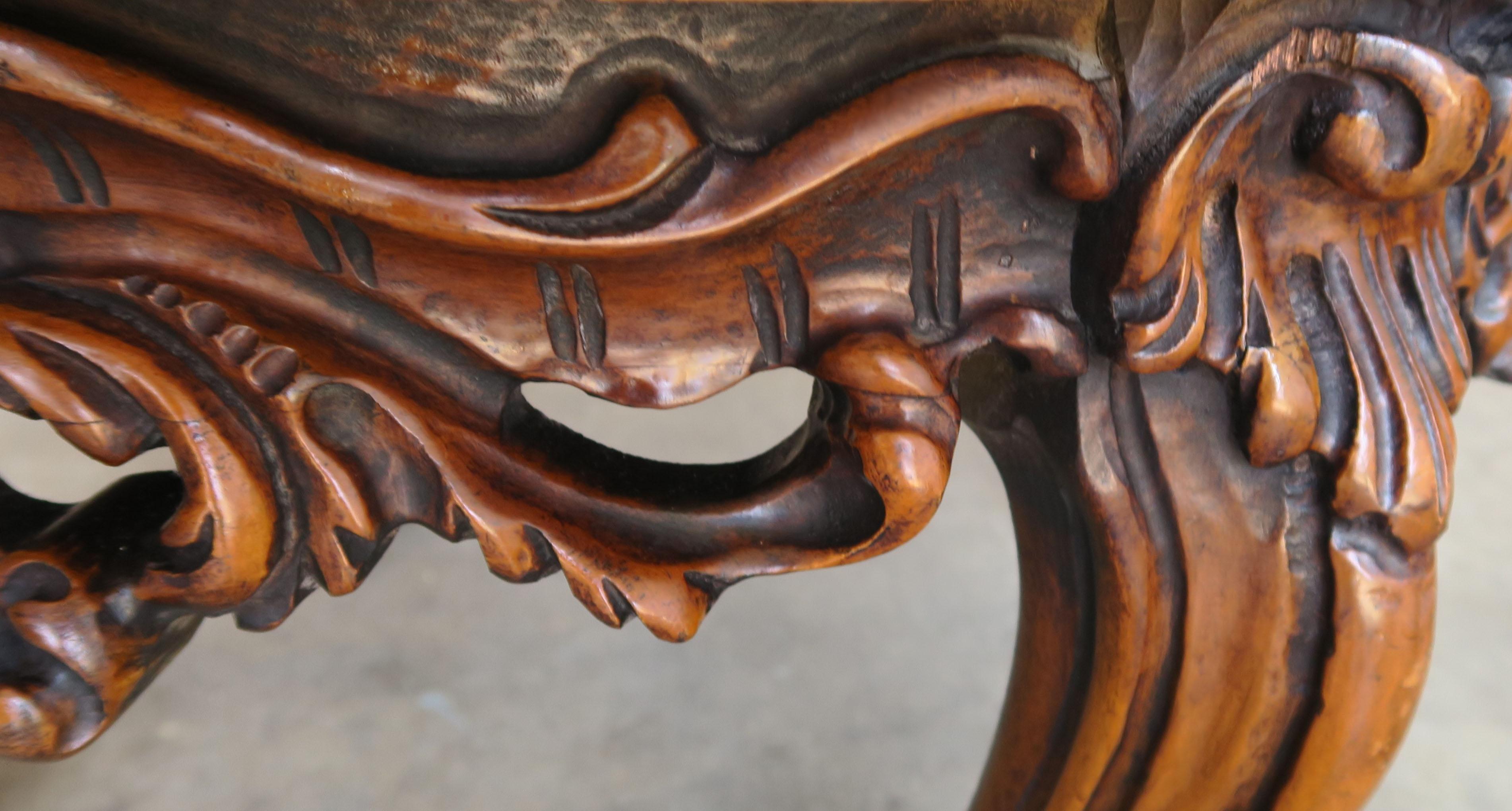 Pair of 1930s Carved Walnut Leather Tufted Ottomans In Distressed Condition In Los Angeles, CA