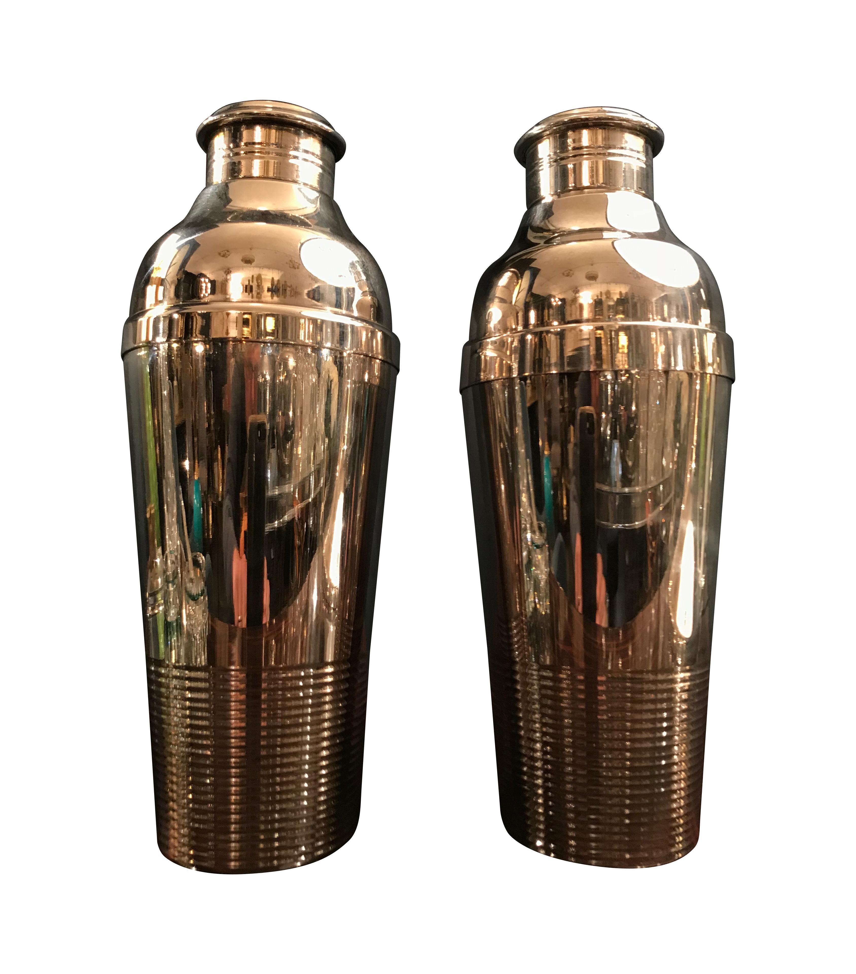 A pair of large 1930s Christofle silver plated cocktail shakers, each stamped on the underside 