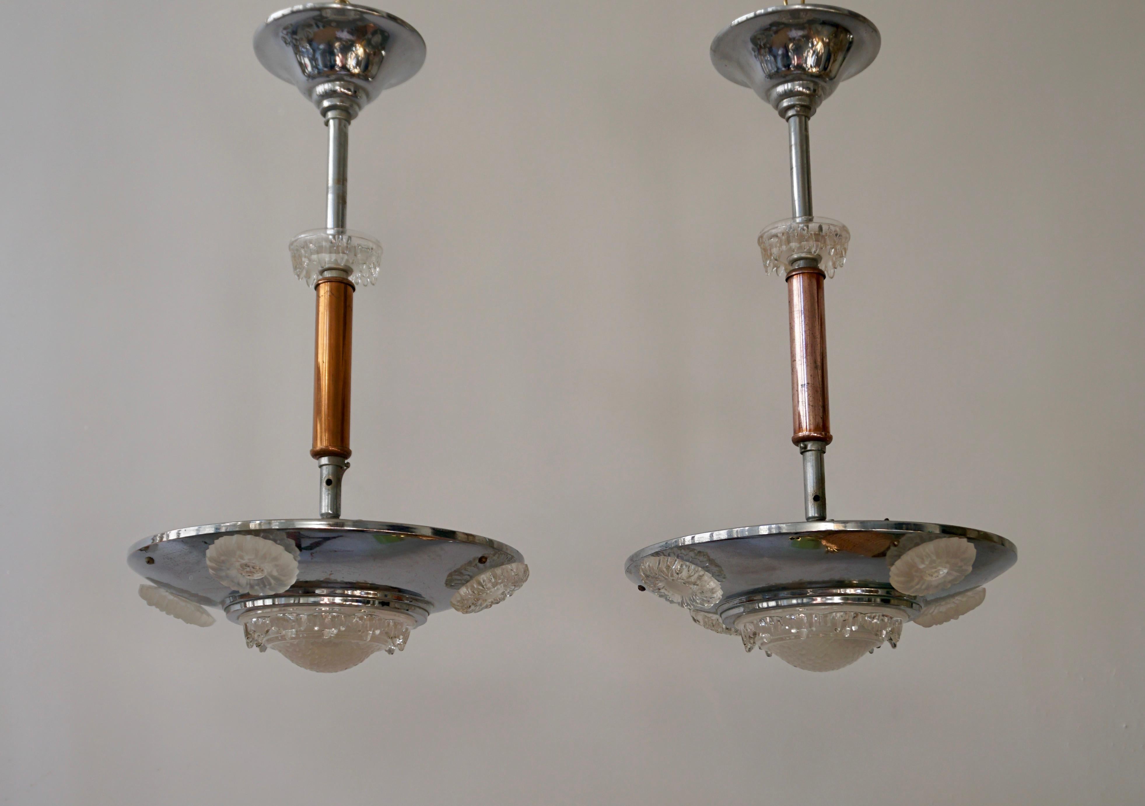 Two Art Deco chandeliers in glass, brass and chrome.

Please note that price is per item not for the set. 