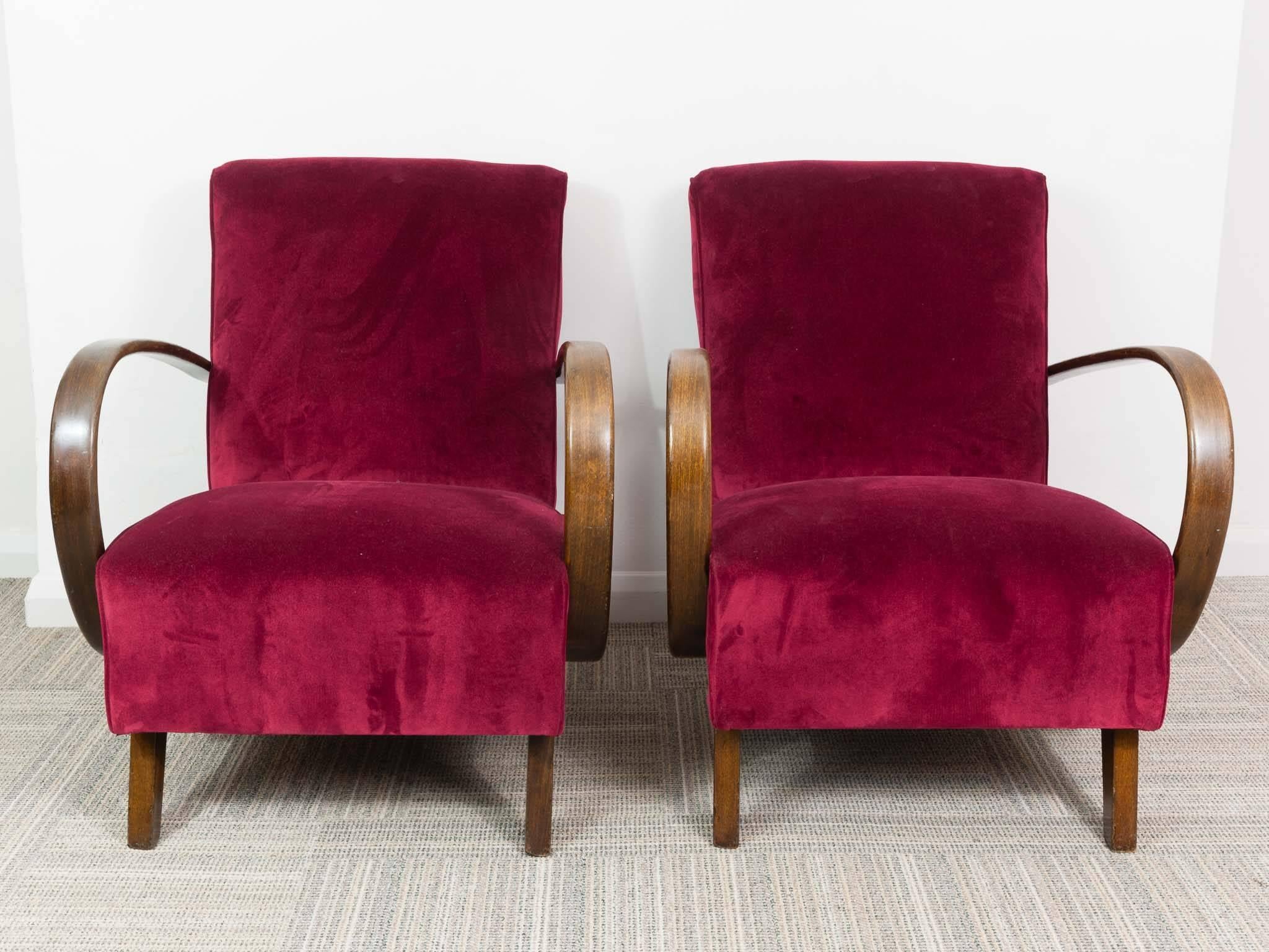 A pair newly upholstered Art Deco armchairs designed by Jindrich Halabala in the Czech Republic during the 1930s. Jindrich Halabala, one of the most prominent Czech furniture designers, worked for UP Závody Brno. The feature bentwood armrest and