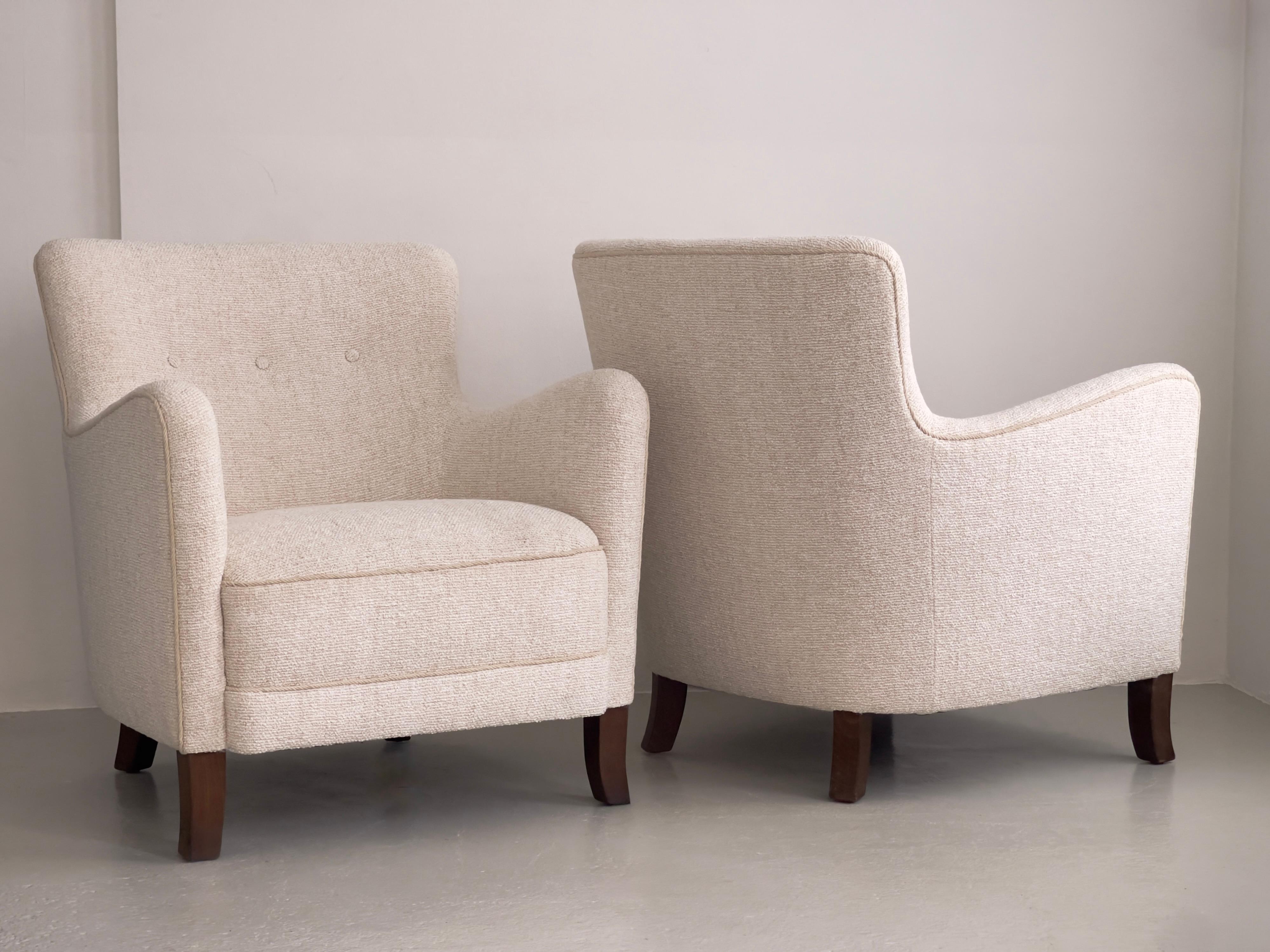 A pair of Danish modern lounge chairs attributed to cabinetmaker Frits Hansen, Denmark, 1930s. These elegant and solidly constructed chairs reflect the refined craftsmanship and architectural sensitivity of early Danish modern design. The frames,