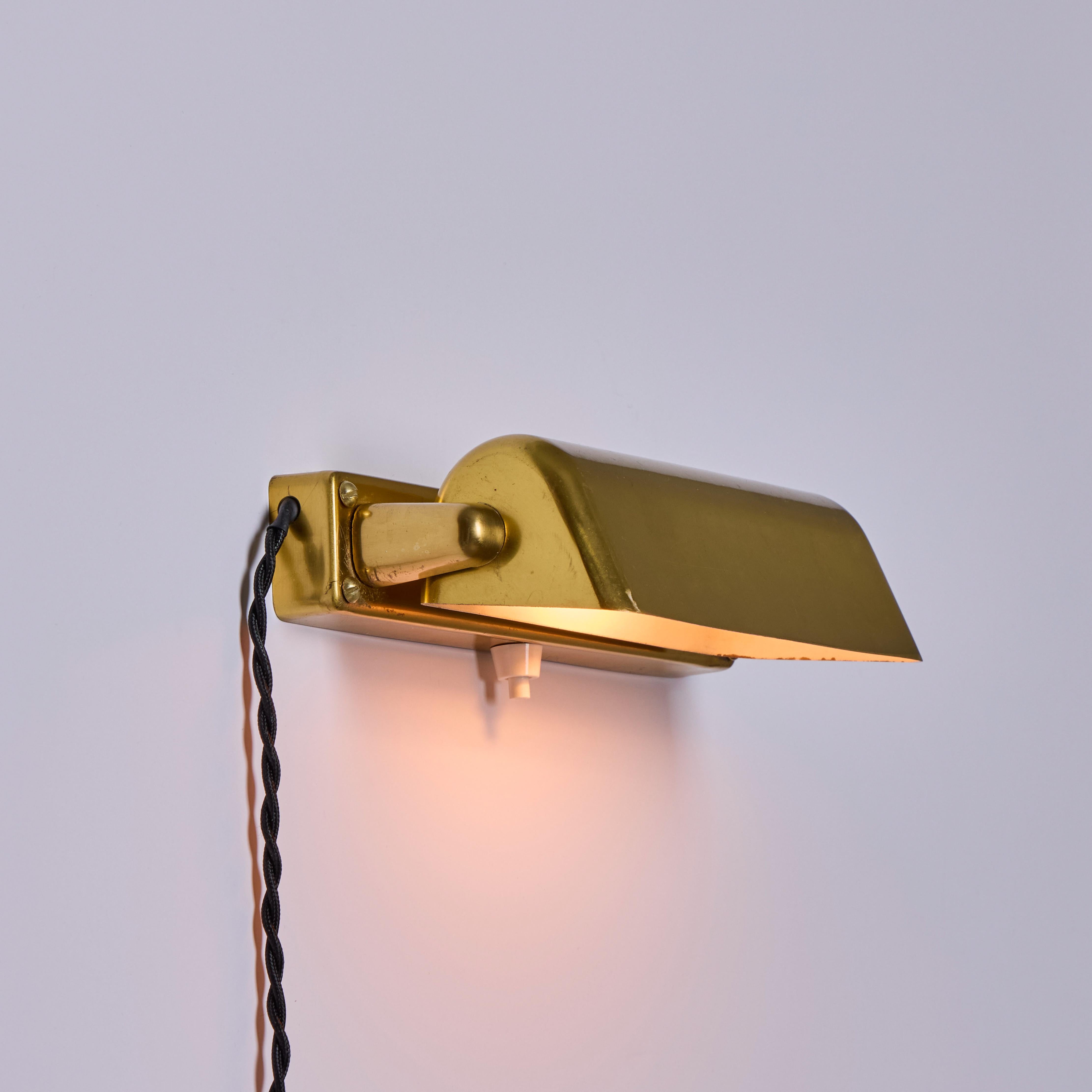 Pair of 1930s Finnish Brass Plug-In Wall Lights Attributed to Paavo Tynell.

A highly refined pair of adjustable rectangular wall lamps executed in attractively patinated brass with white painted interior shade that rotates up and down with original
