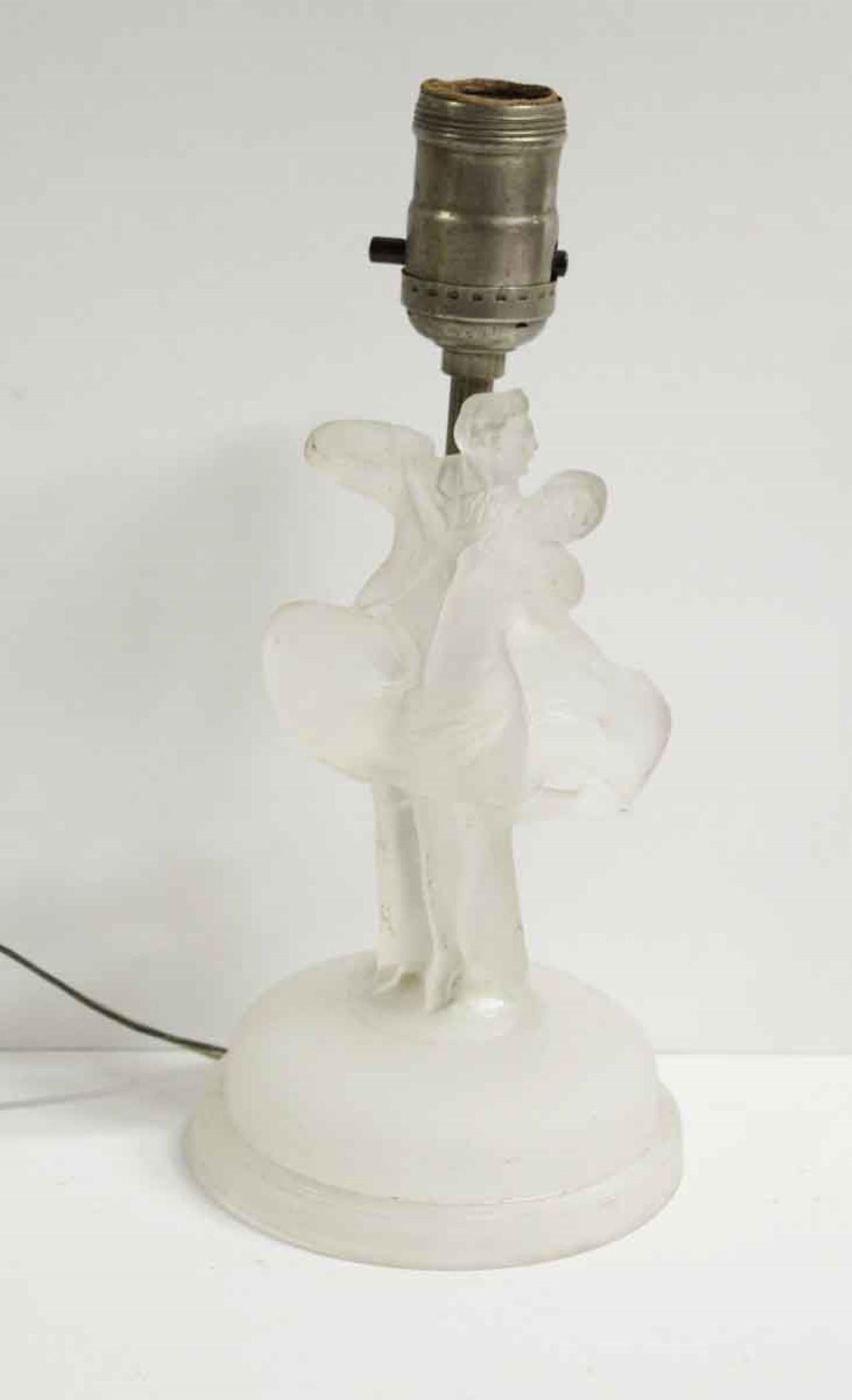 Frosted glass elegant vanity lamps carved into a man and woman dancing. There are minor chips at the base and some dark scratches. Please see the photos. Priced as a pair. Price includes restoration. This can be seen at our 400 Gilligan St location